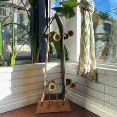 COR Surf stand next to foot and skateboard showing compact footprint and scale