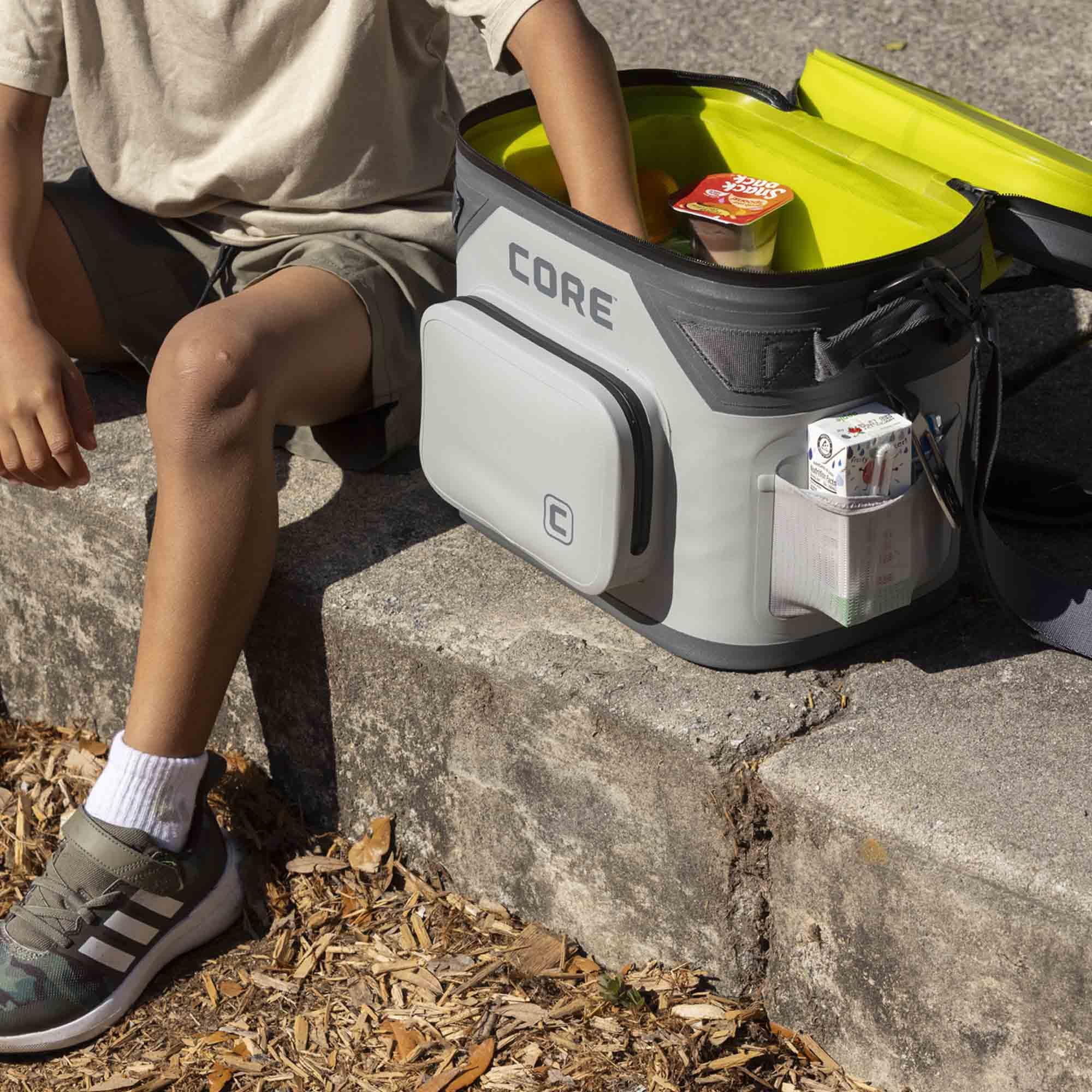 CORE cooler on a beach towel with snacks to illustrate picnic-ready convenience
