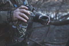 Cupped Waterfowl thermos placed in a blind demonstrating concealment and temperature retention benefit