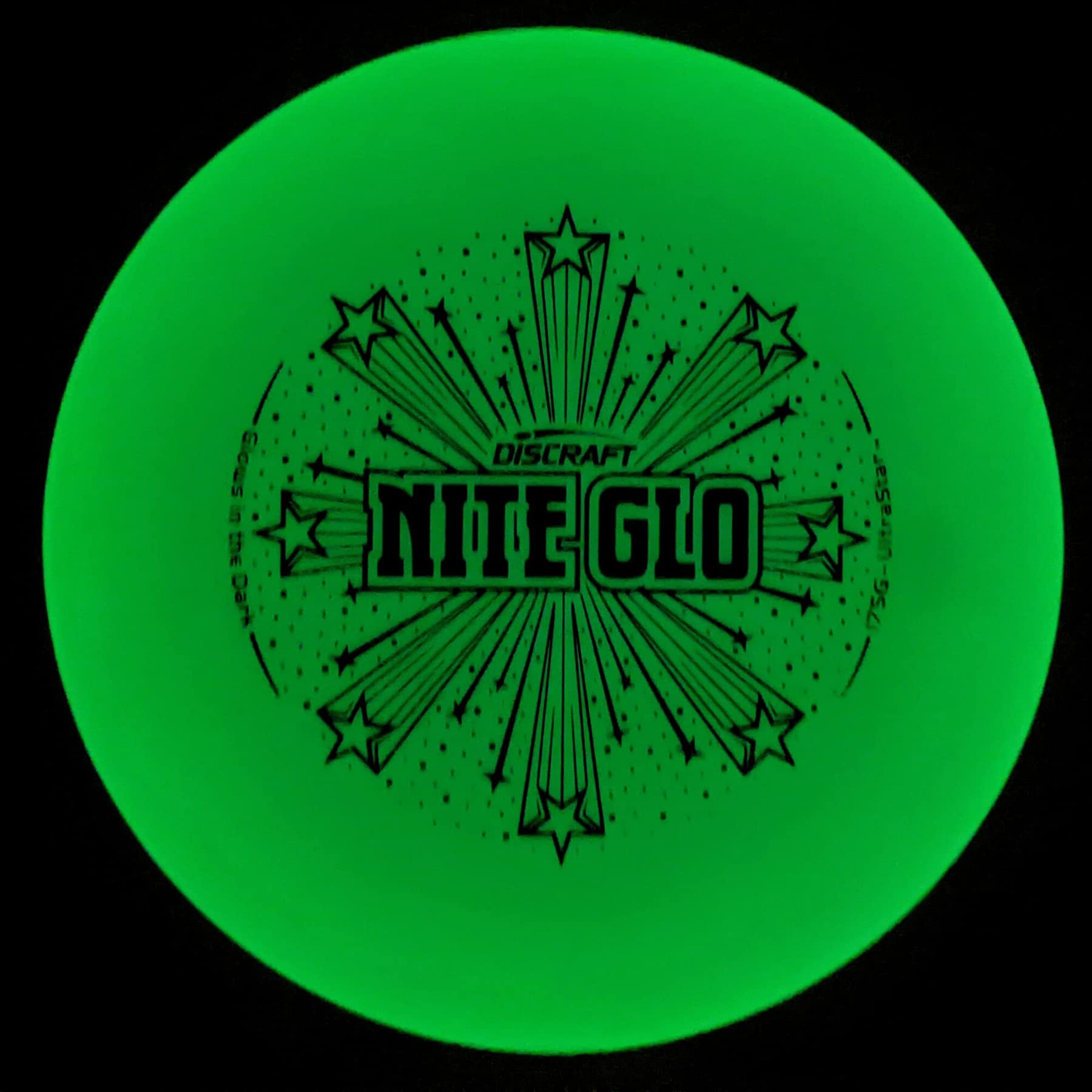 Discraft Ultra-Star held in hand glowing, showing grip detail and night-play visibility