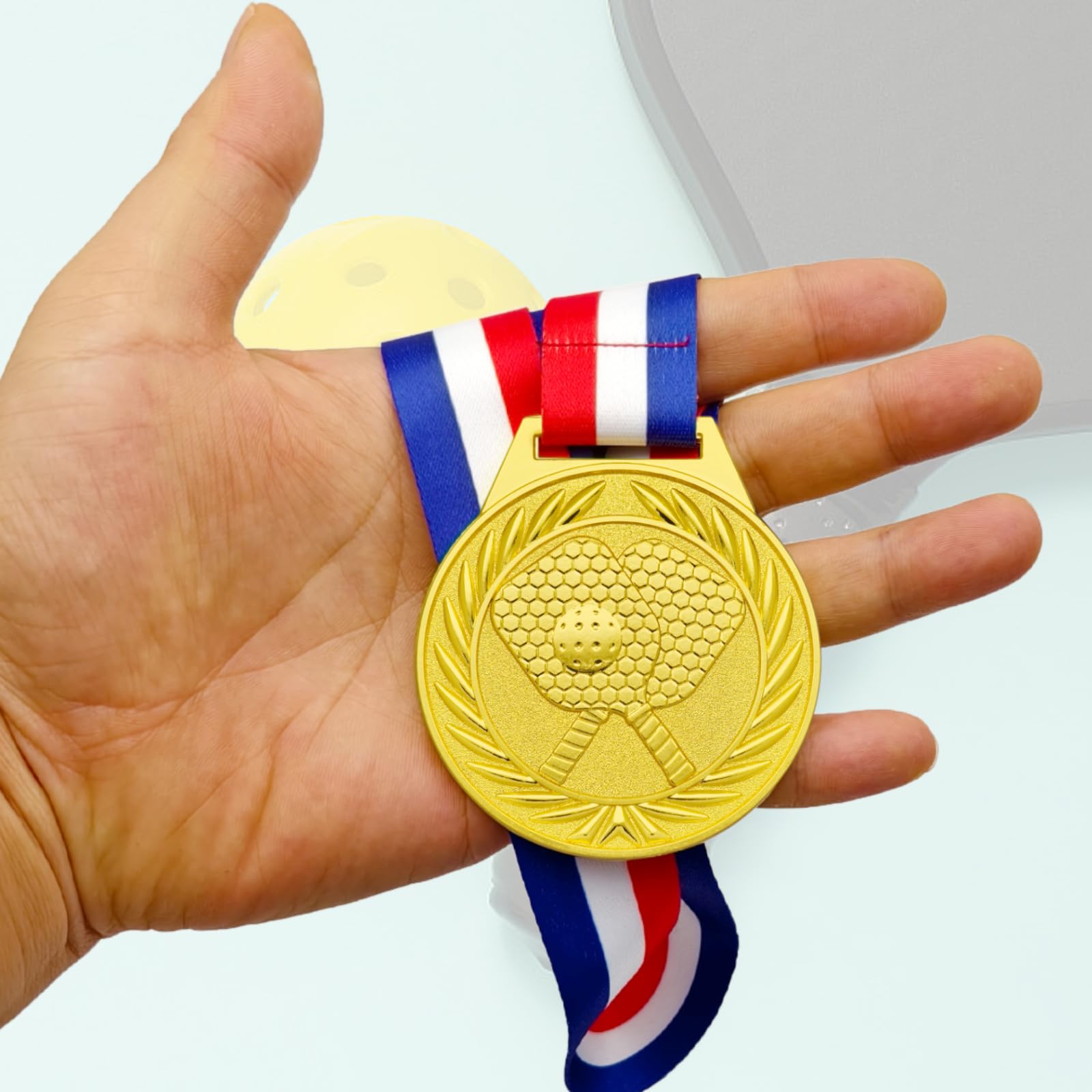 Donrime medal held in hand for scale showing 2.56-inch size and collectible weight