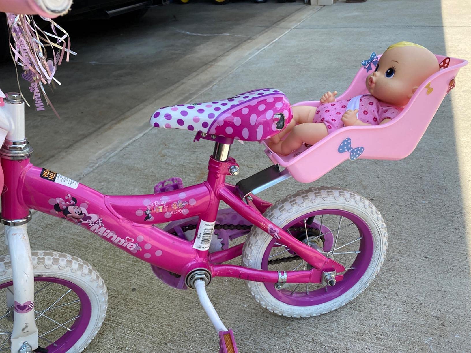 DRBIKE lifestyle image of child riding with doll seat showing playful engagement