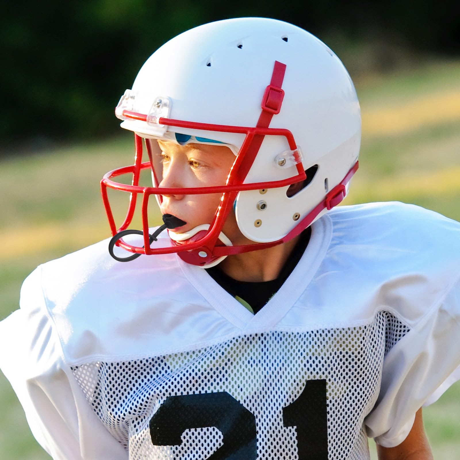 Dunzy mouth guard next to ruler showing compact youth size