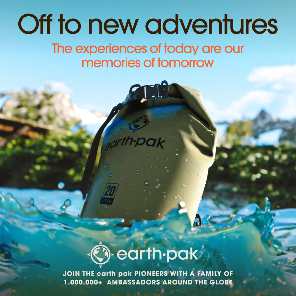 Earth Pak on beach next to paddleboard showing travel-ready protection
