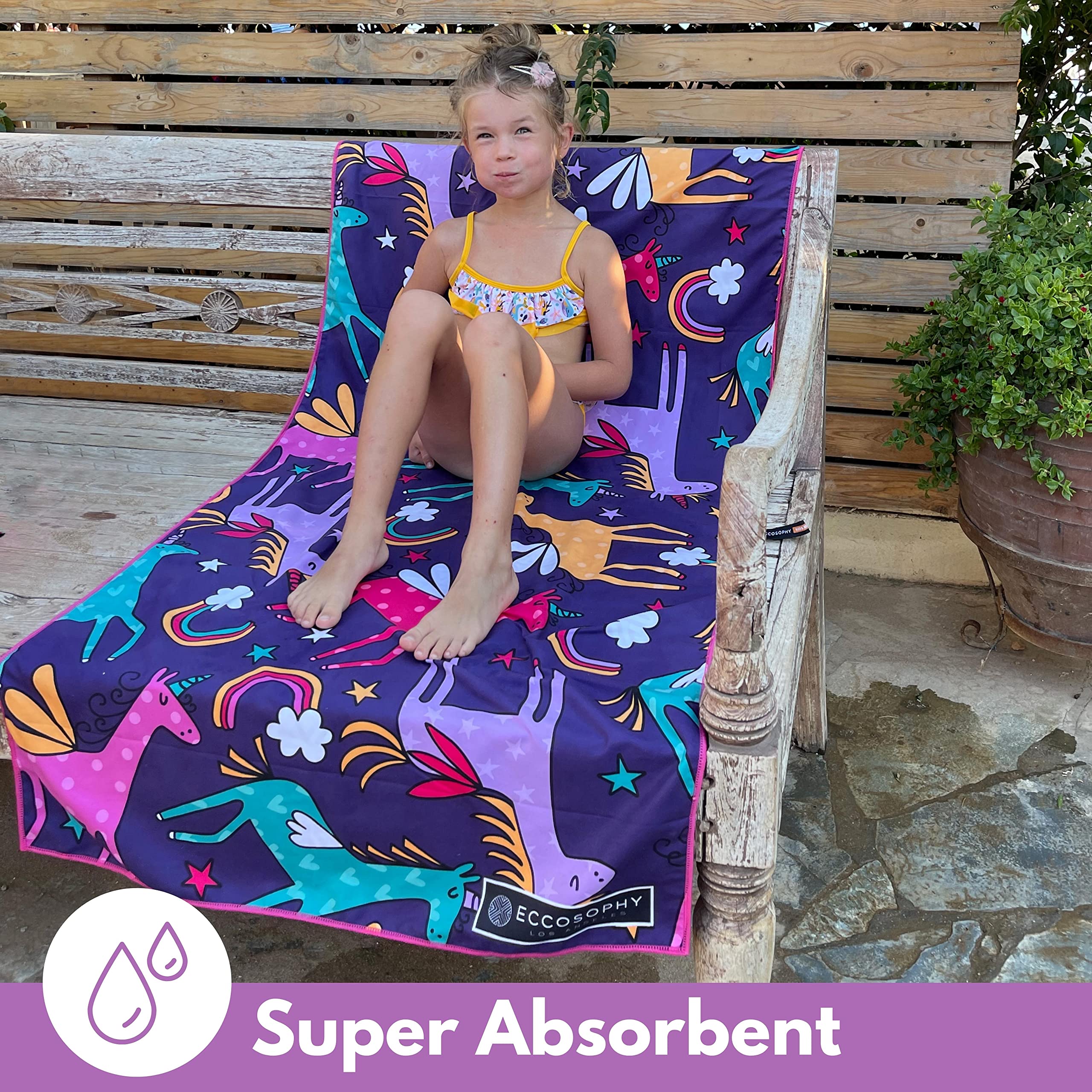 ECCOSOPHY toddler wrapped in towel at beach demonstrating sand-free convenience