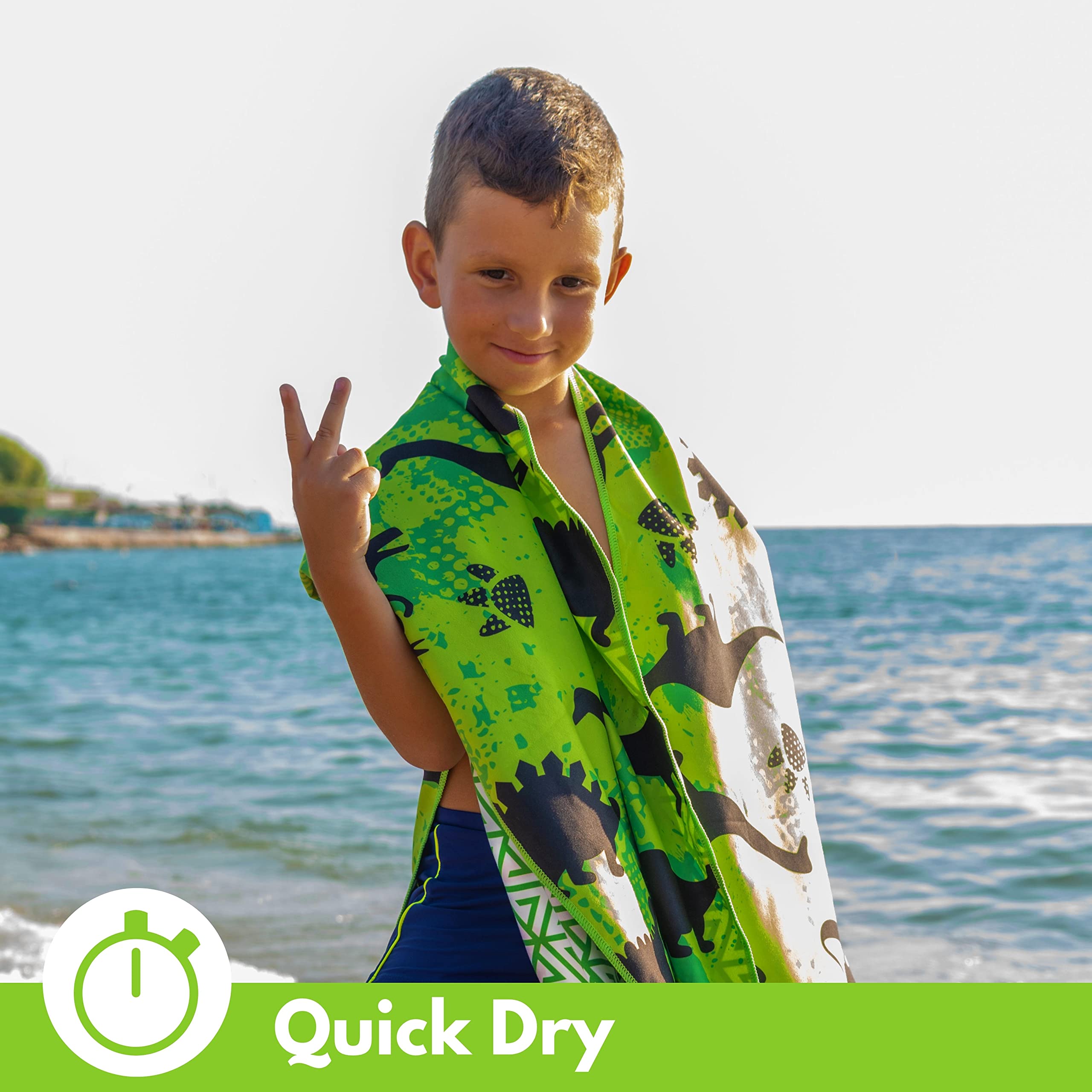 ECCOSOPHY towel in use wrapping toddler at beach for warmth and sand-free comfort