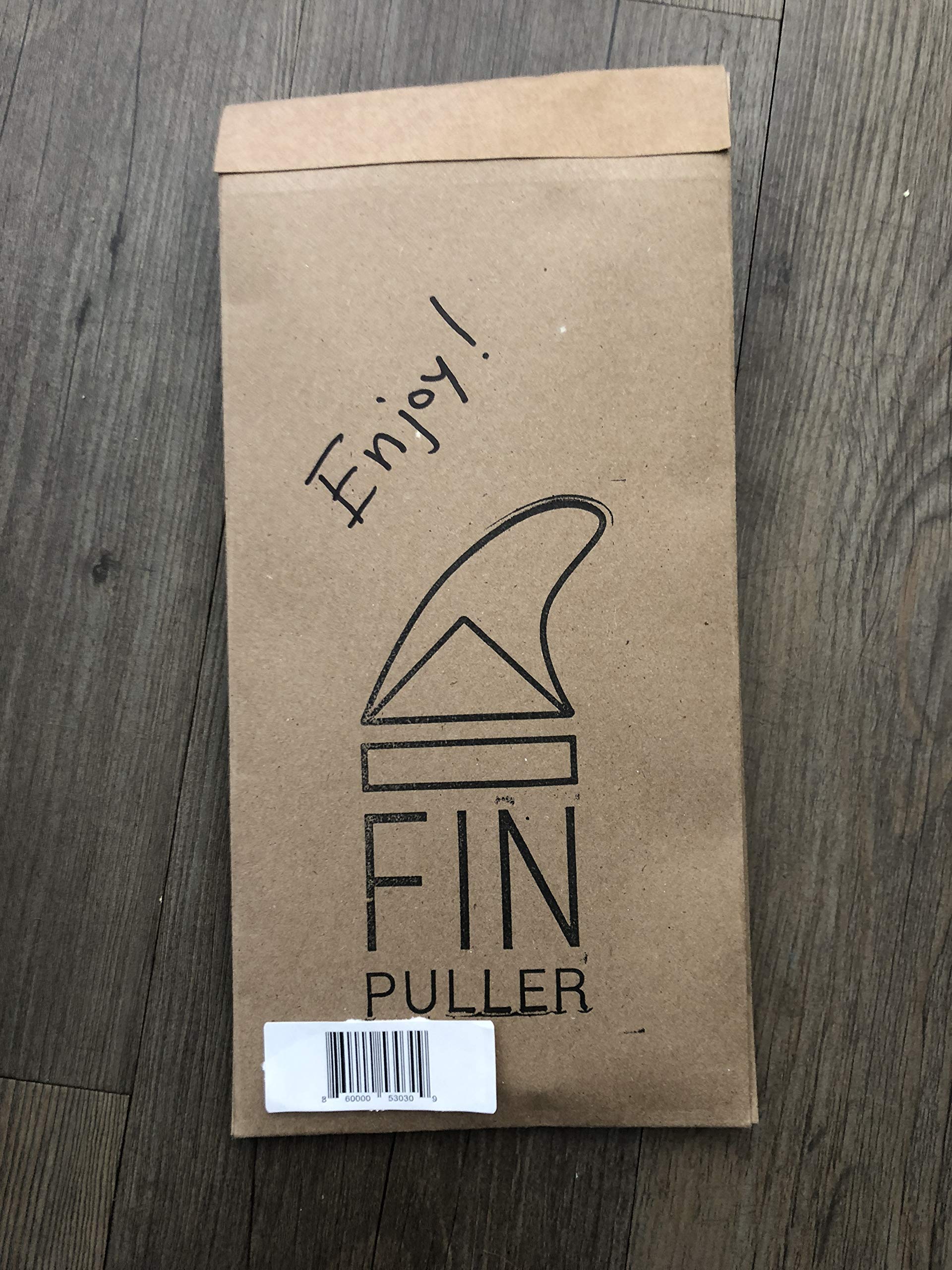 FINPULLER next to a fin key showing compact size for easy storage
