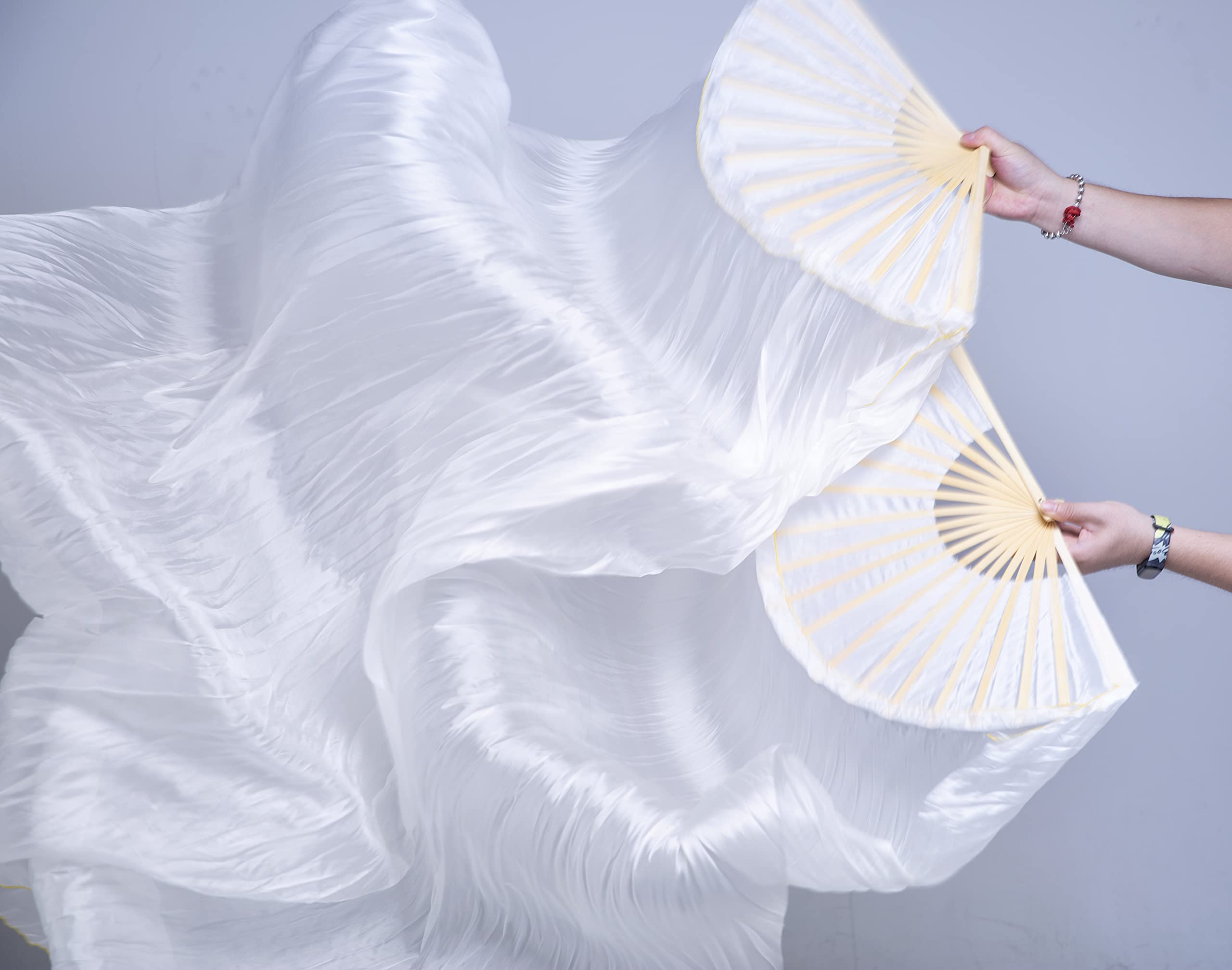 FJYIRI dancer performing with fan veils on stage for enhanced visual effect
