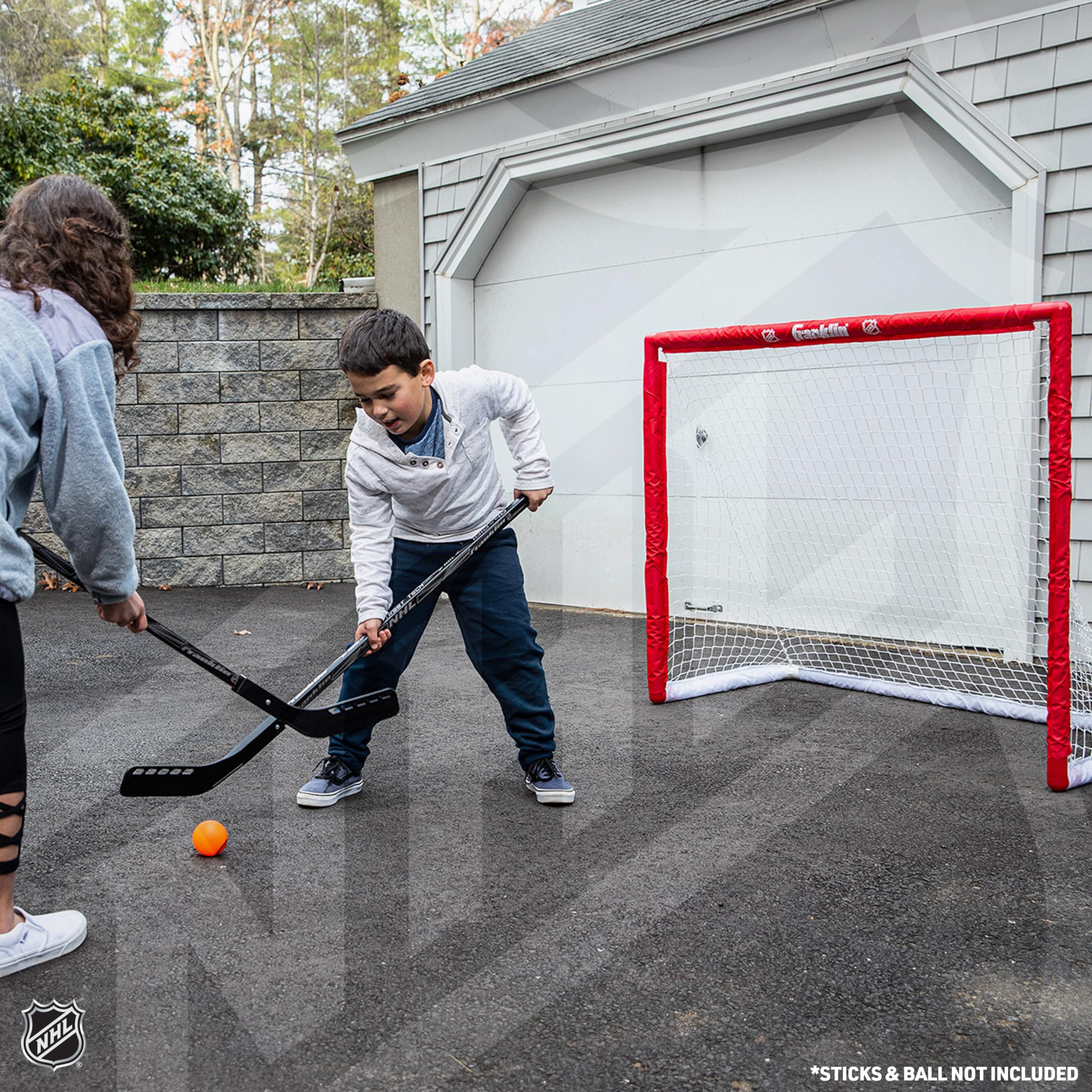 Franklin Sports goal beside hockey stick showing scale for youth and beginner players