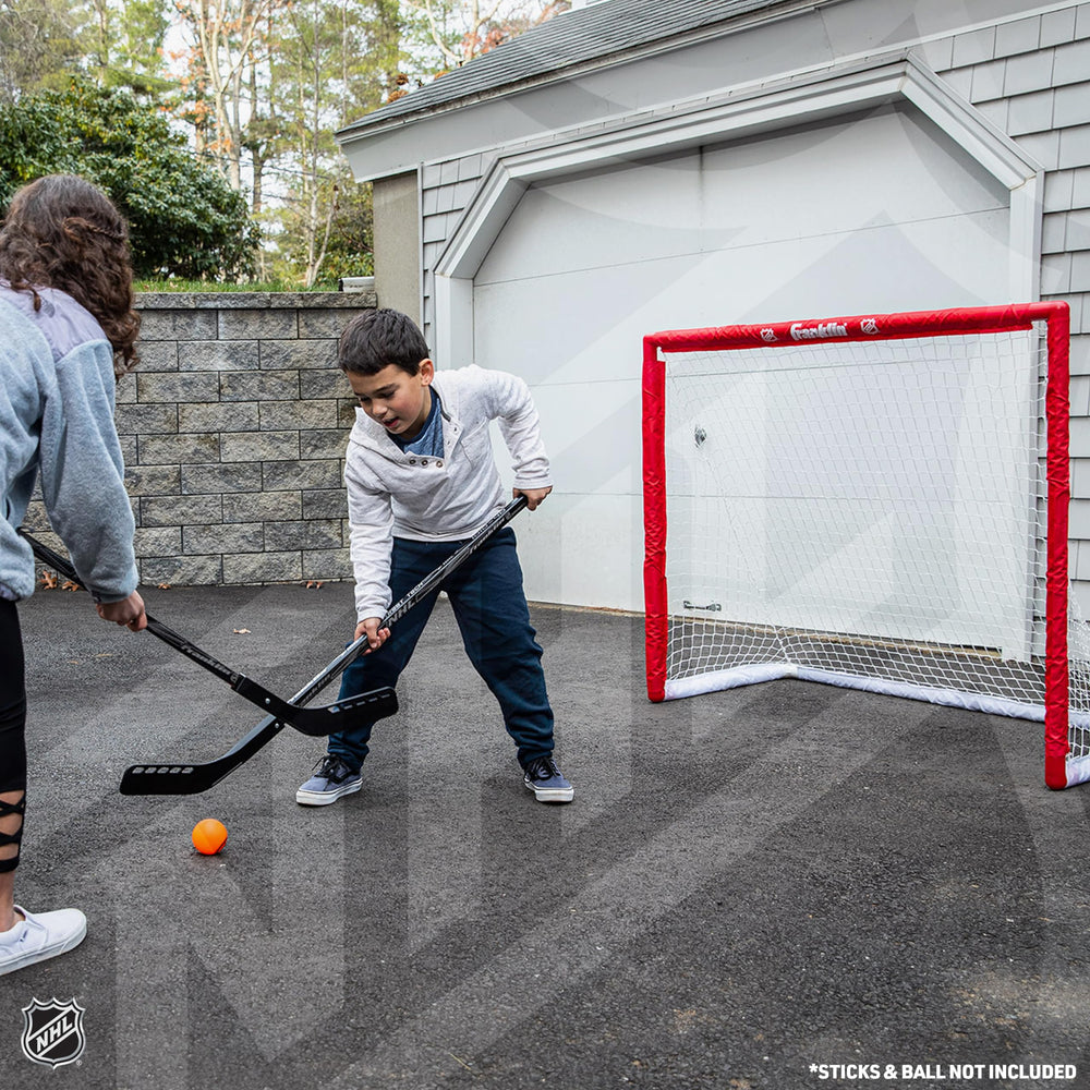 Franklin Sports goal beside hockey stick showing scale for youth and beginner players