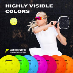 Franklin Sports ball in hand near ruler showing official size and weight accuracy