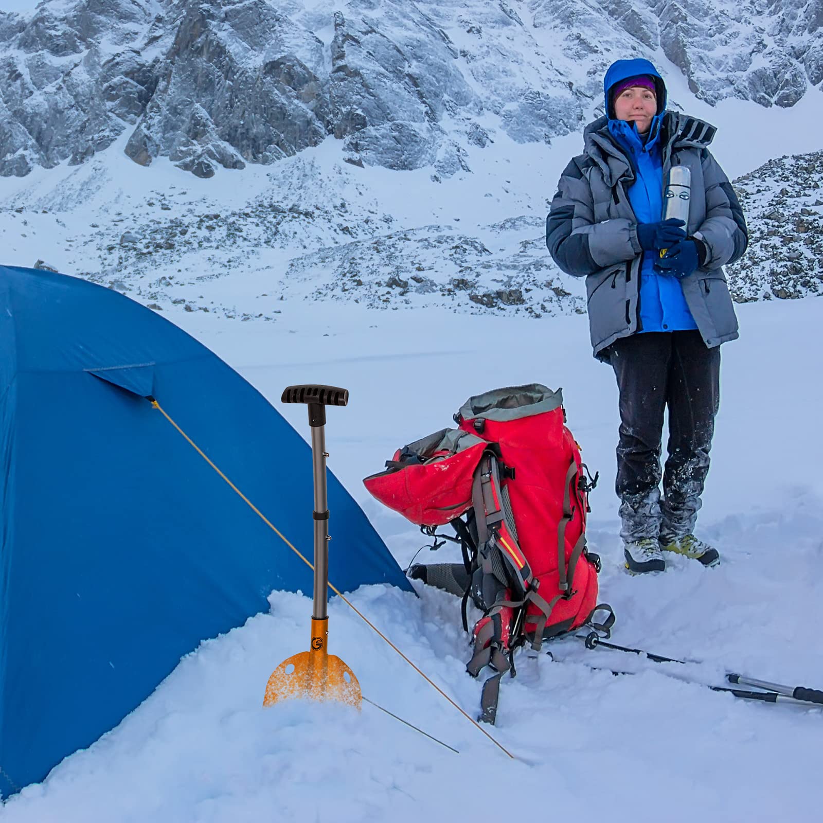 G2 lifestyle image of skier using shovel to clear snow efficiently