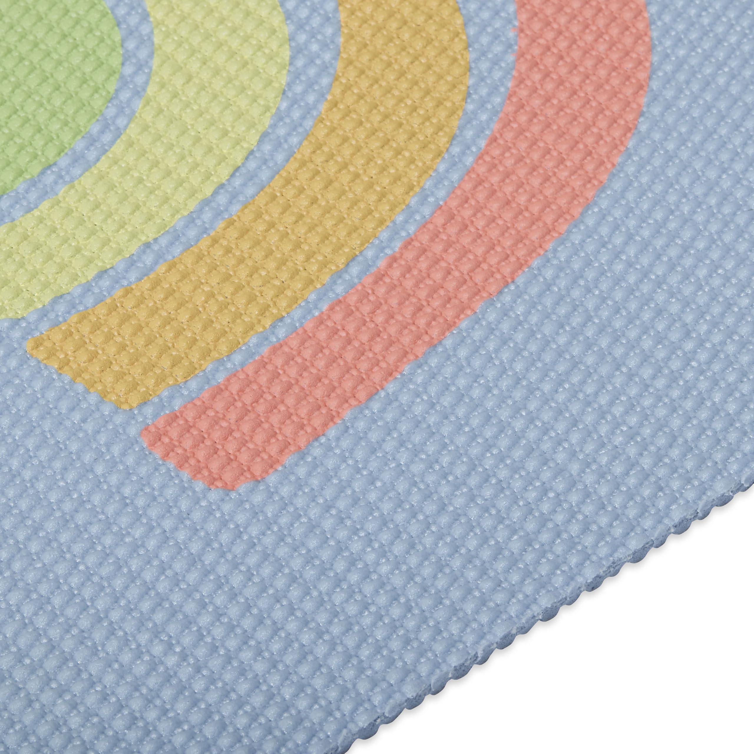 Gaiam kids yoga mat next to a child for scale showing appropriate 60 by 24 inch size benefit