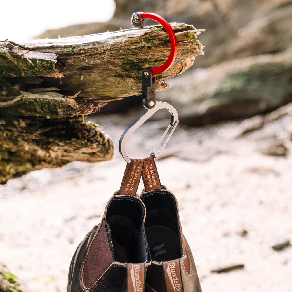 GEAR AID HEROCLIP holding a duffel from a fence providing secure outdoor storage