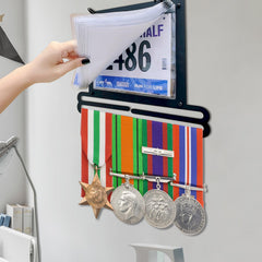 GEMLORD installed in a home gym displaying medals and bibs for daily motivation