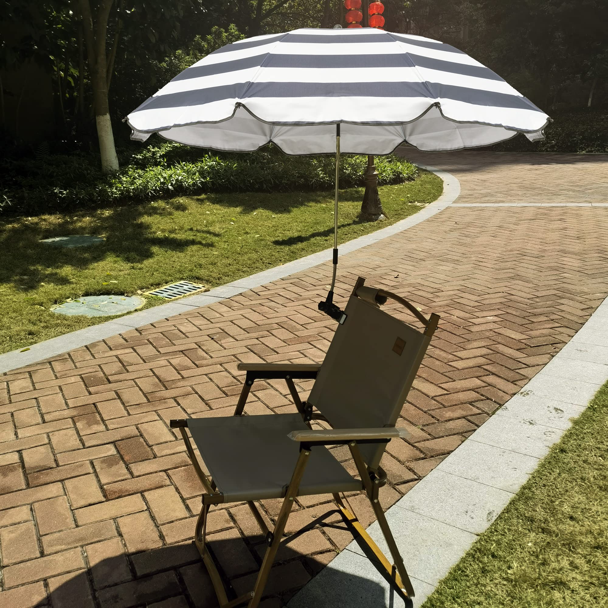 GRANDMEI umbrella next to hand showing compact folded size benefit