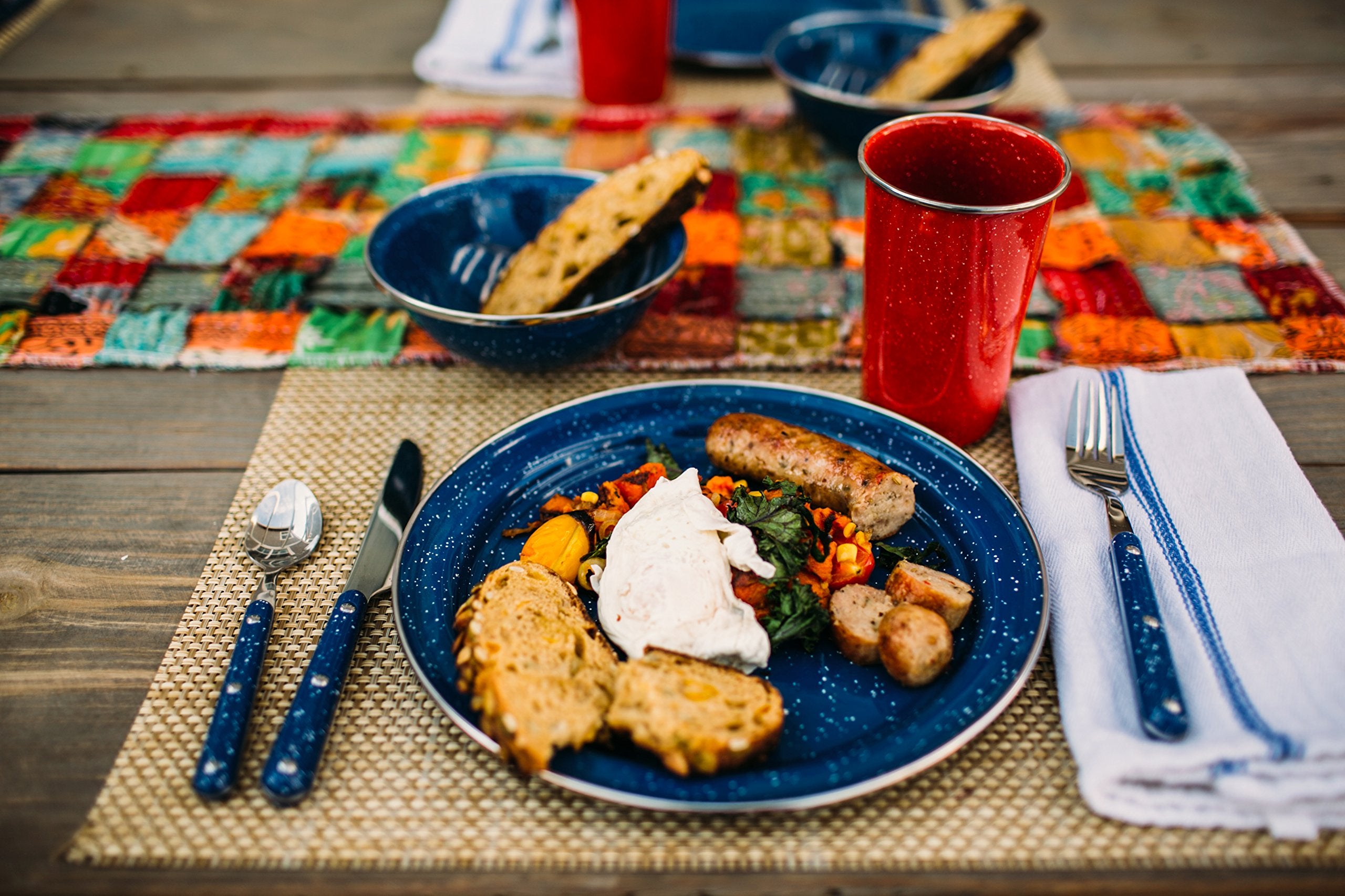 GSI Outdoors lifestyle scene of campers using Pioneer cutlery around camp table showing practical outdoor use