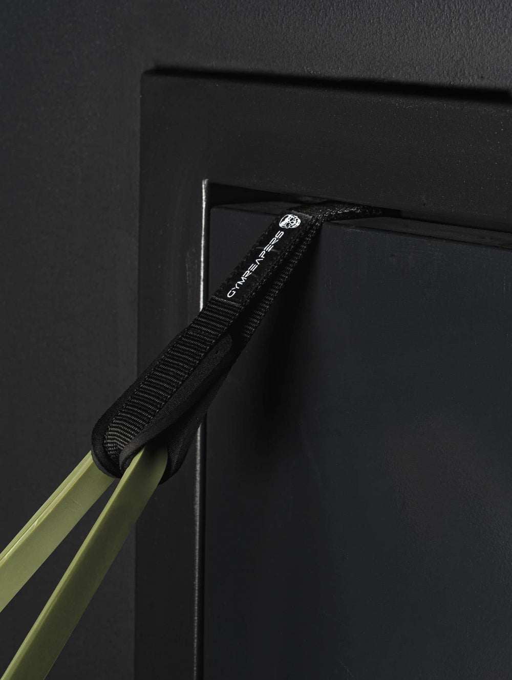 Gymreapers handles next to water bottle showing compact size and portability