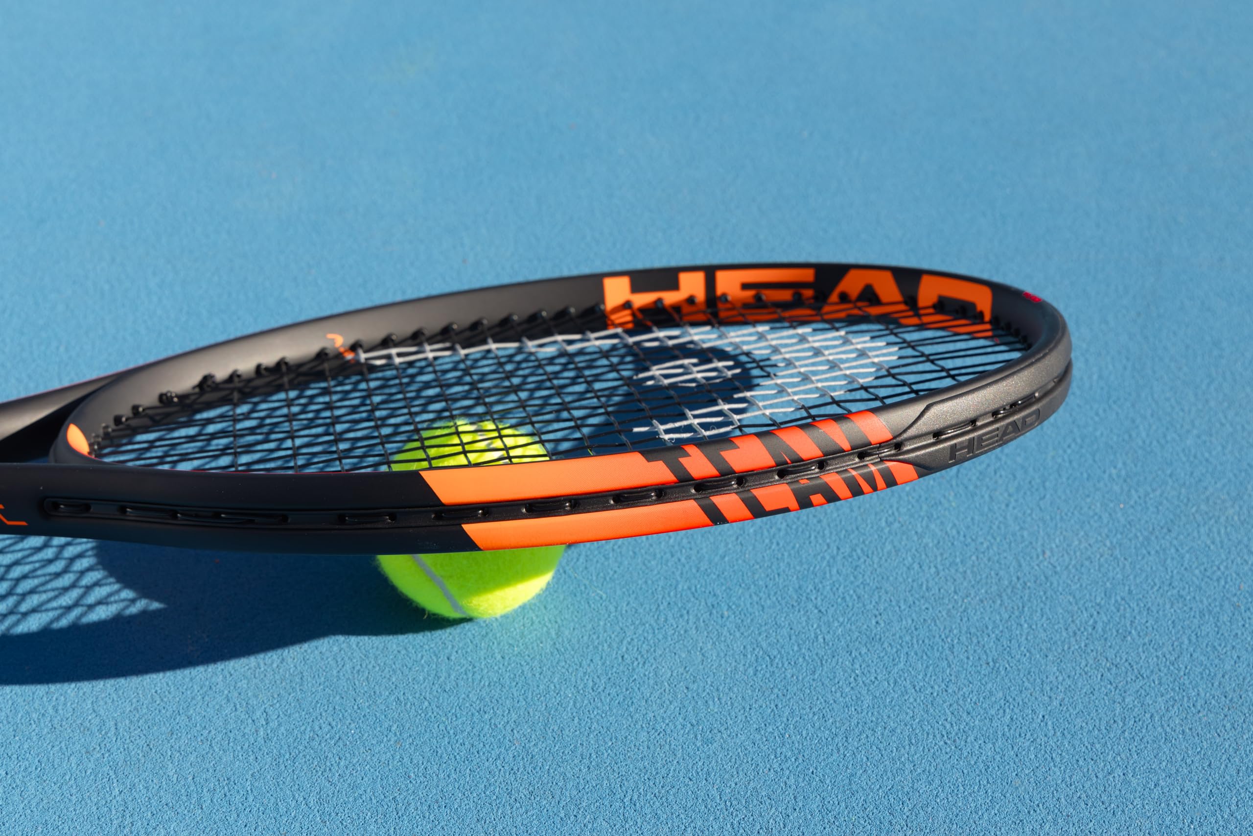 HEAD racquet hitting ball on court demonstrating spin and power generation
