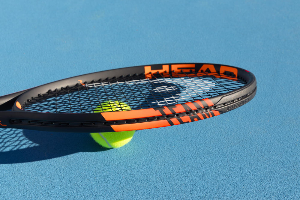 HEAD racquet hitting ball on court demonstrating spin and power generation