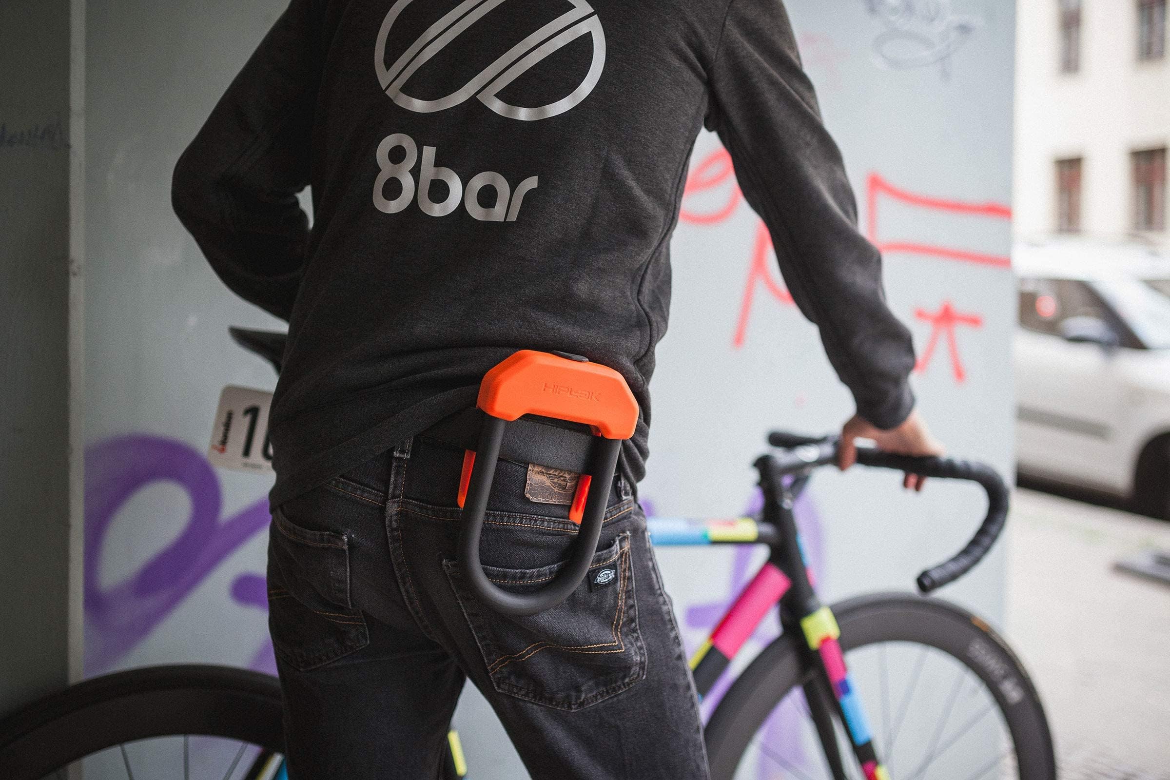 Hiplok DX held in hand for scale showing lightweight 2.4 lbs portability benefit