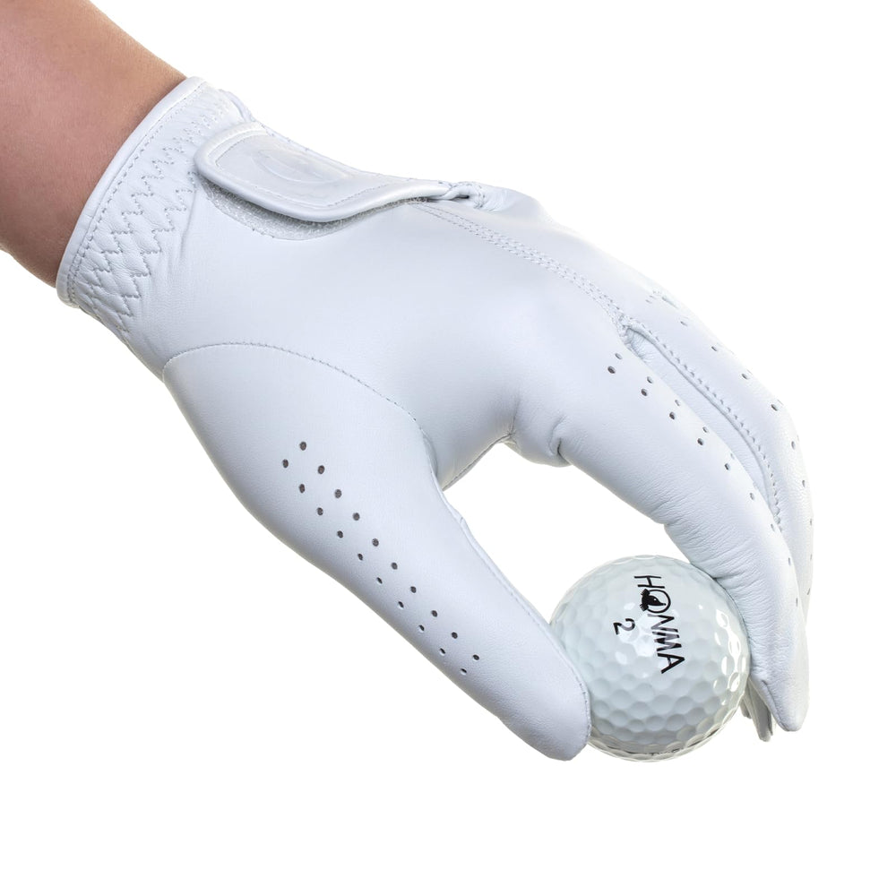 Honma glove next to ruler showing medium size and accurate fit guidance