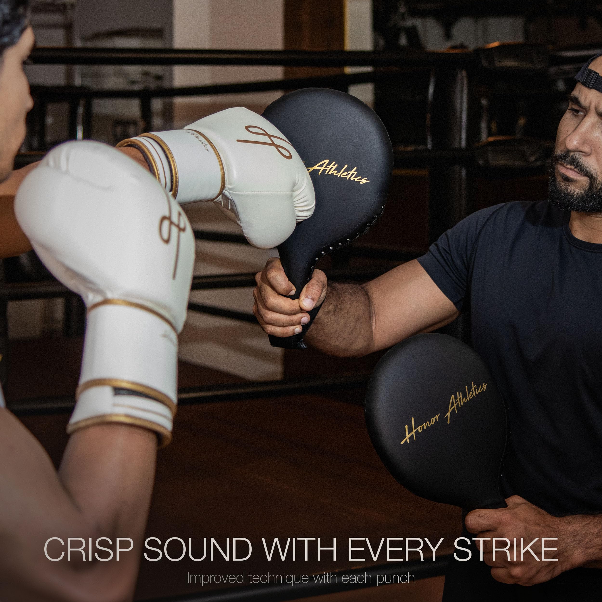 Honor Athletics coach holding paddle with fighter striking to improve speed and accuracy