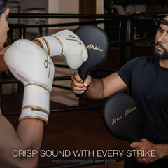 Honor Athletics coach holding paddle with fighter striking to improve speed and accuracy