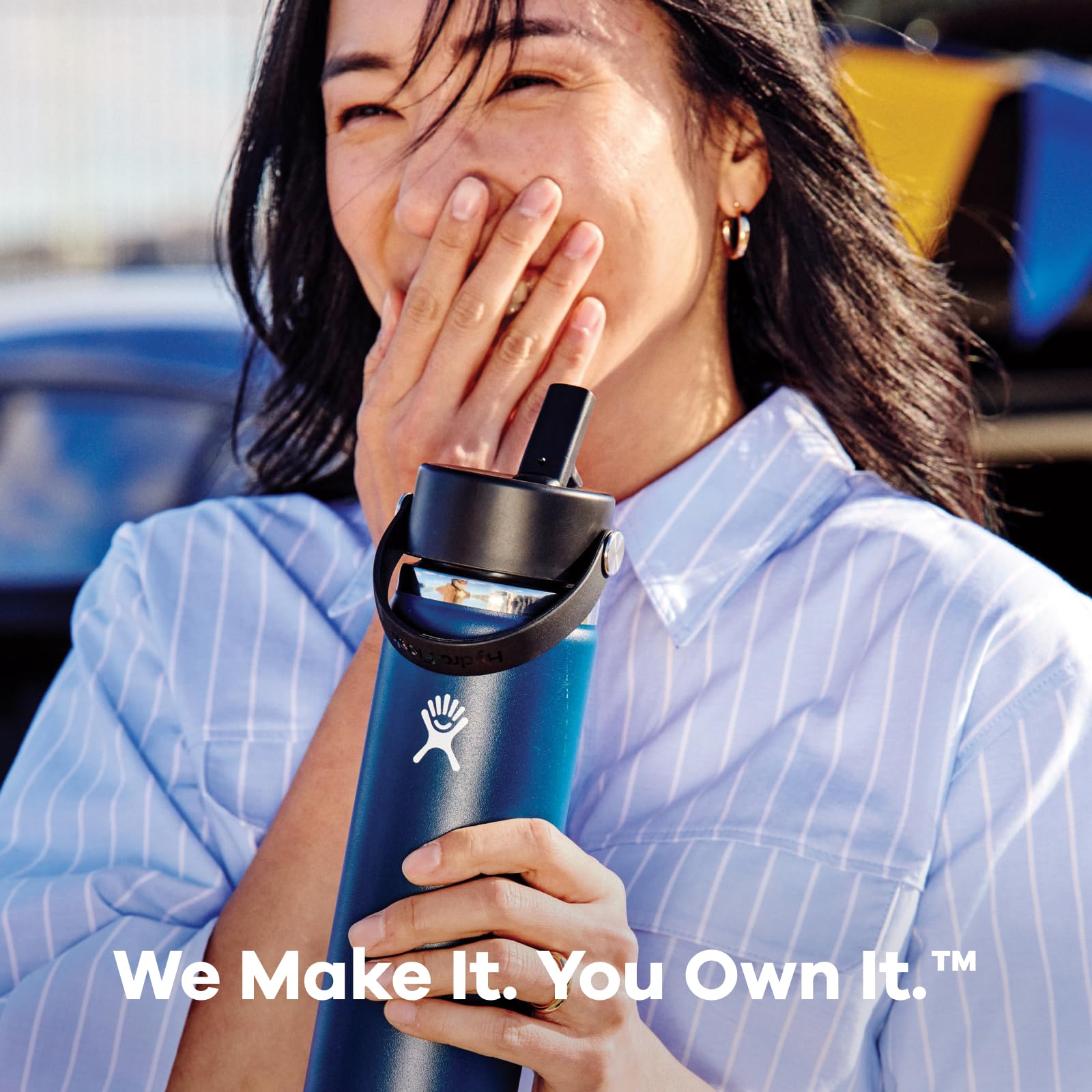 Hydro Flask Coconut Cream bottle clipped to backpack for on-the-go hydration