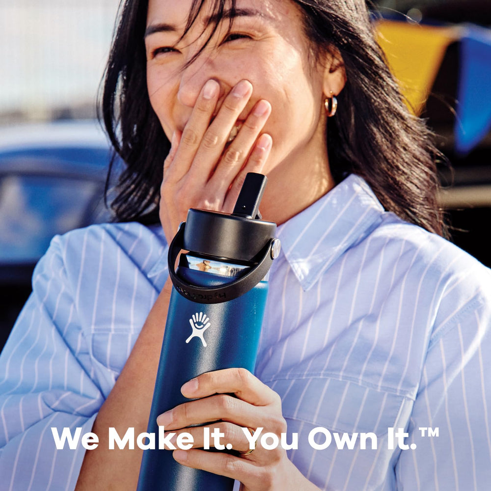 Hydro Flask Coconut Cream bottle clipped to backpack for on-the-go hydration
