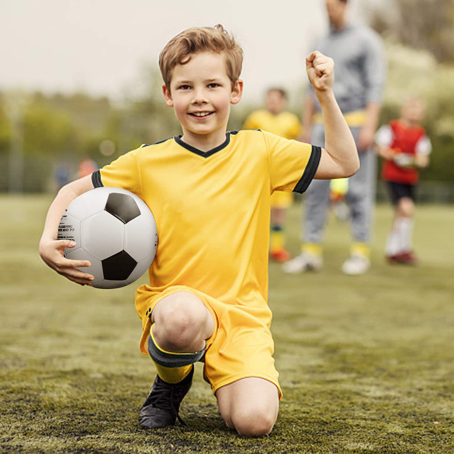 Kenon ball beside adult hand showing size and scale for age-appropriate play