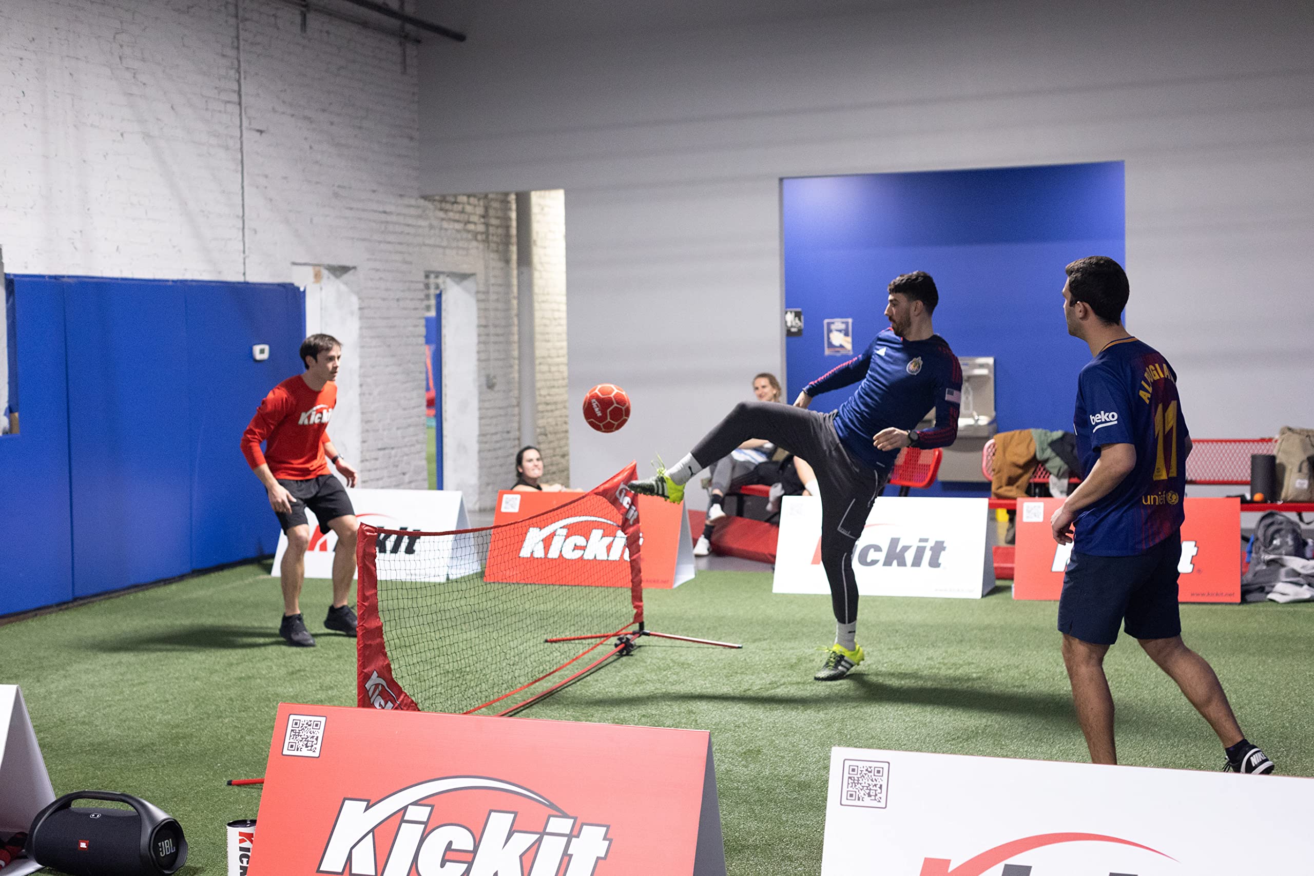 Kickit ball on tennis court mid-play showing versatility across surfaces