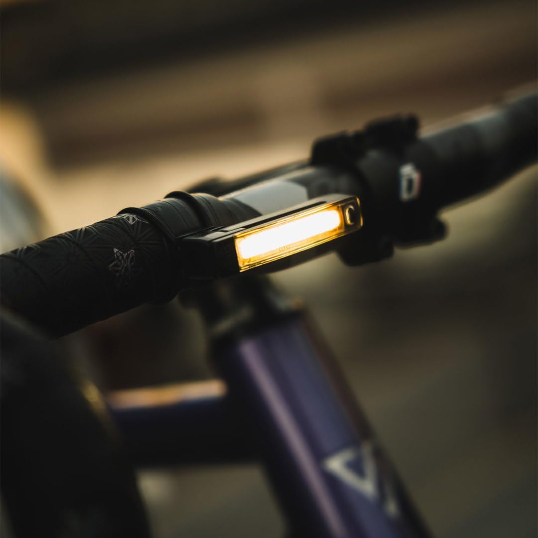 KNOG Plus beside a coin to show ultralight 17 g weight and compact size