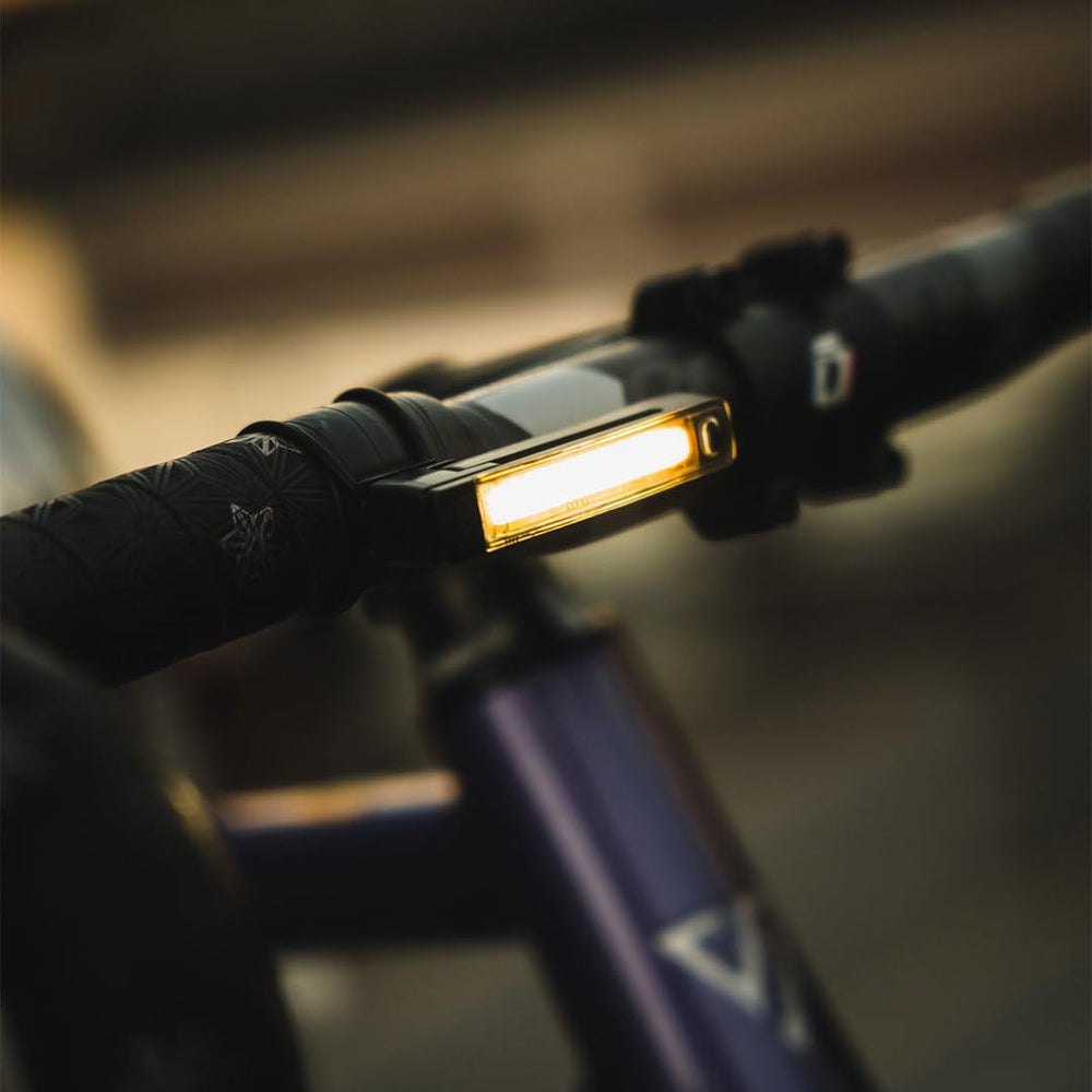KNOG Plus beside a coin to show ultralight 17 g weight and compact size