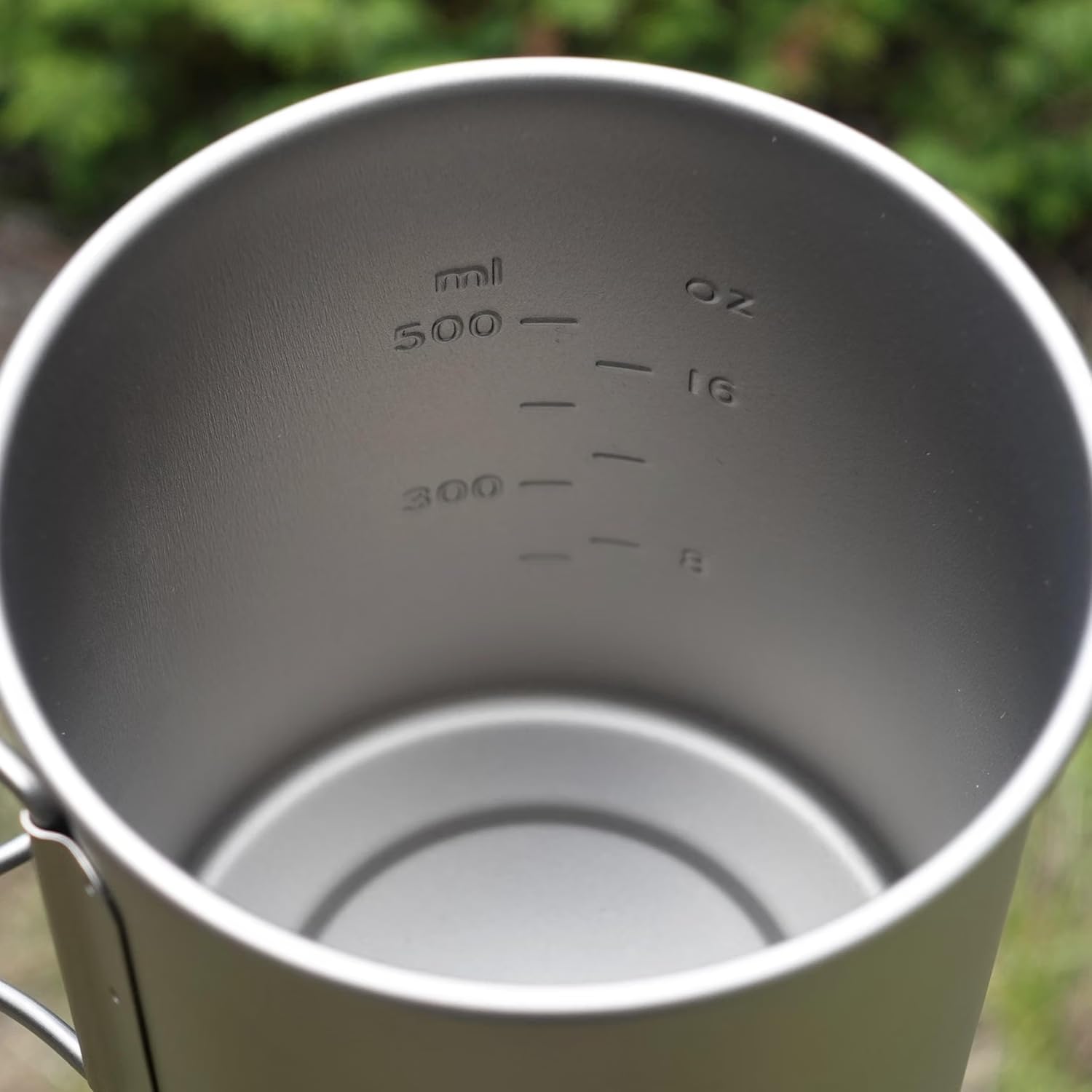 Kuvik pot at campsite on log showing outdoor use and minimalist cooking benefit