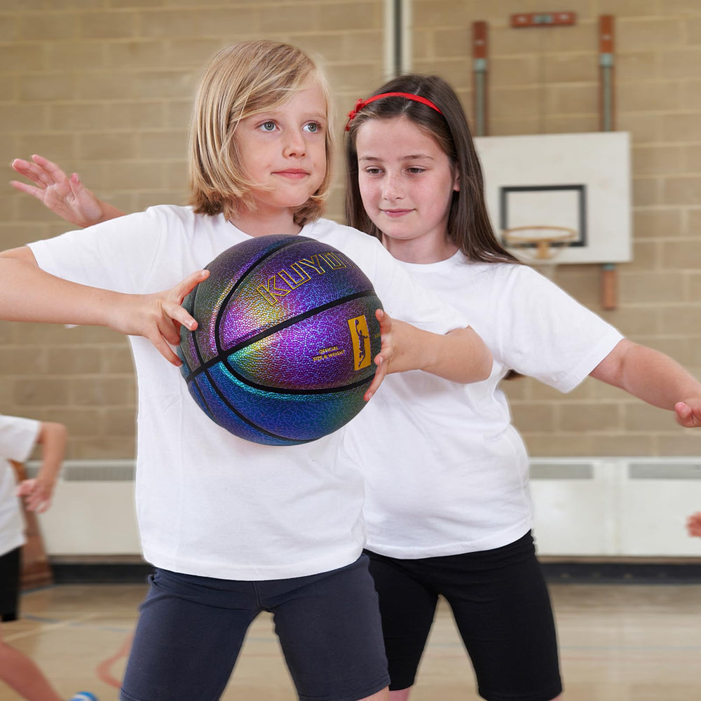 KUYOTQ basketball in hand for scale showing youth-sized 25.5 inch benefit