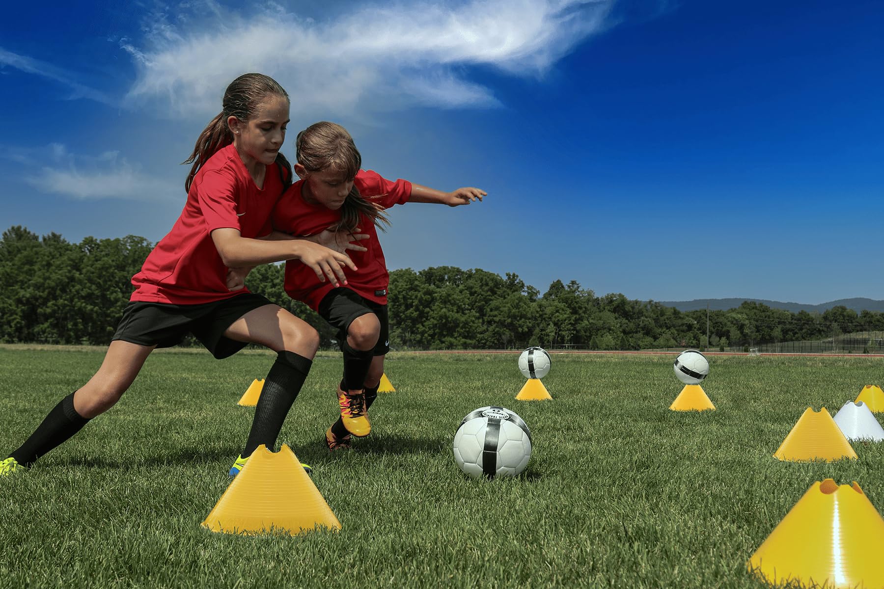 Kwik Goal cone next to a trainer's foot illustrating 6 inch height and scale