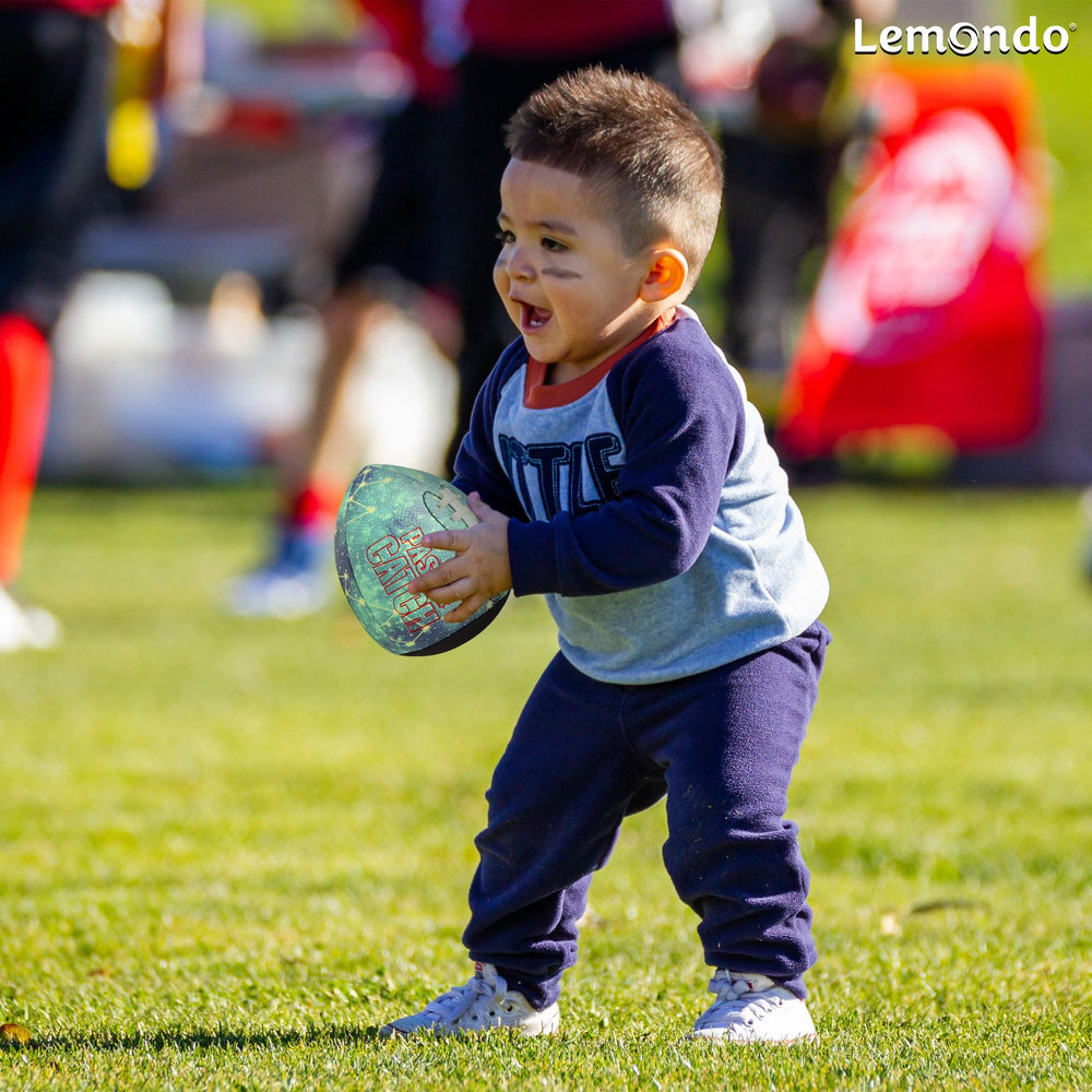 Lemondo rebounding football striking a backyard wall to illustrate consistent bounce for solo throwing drills