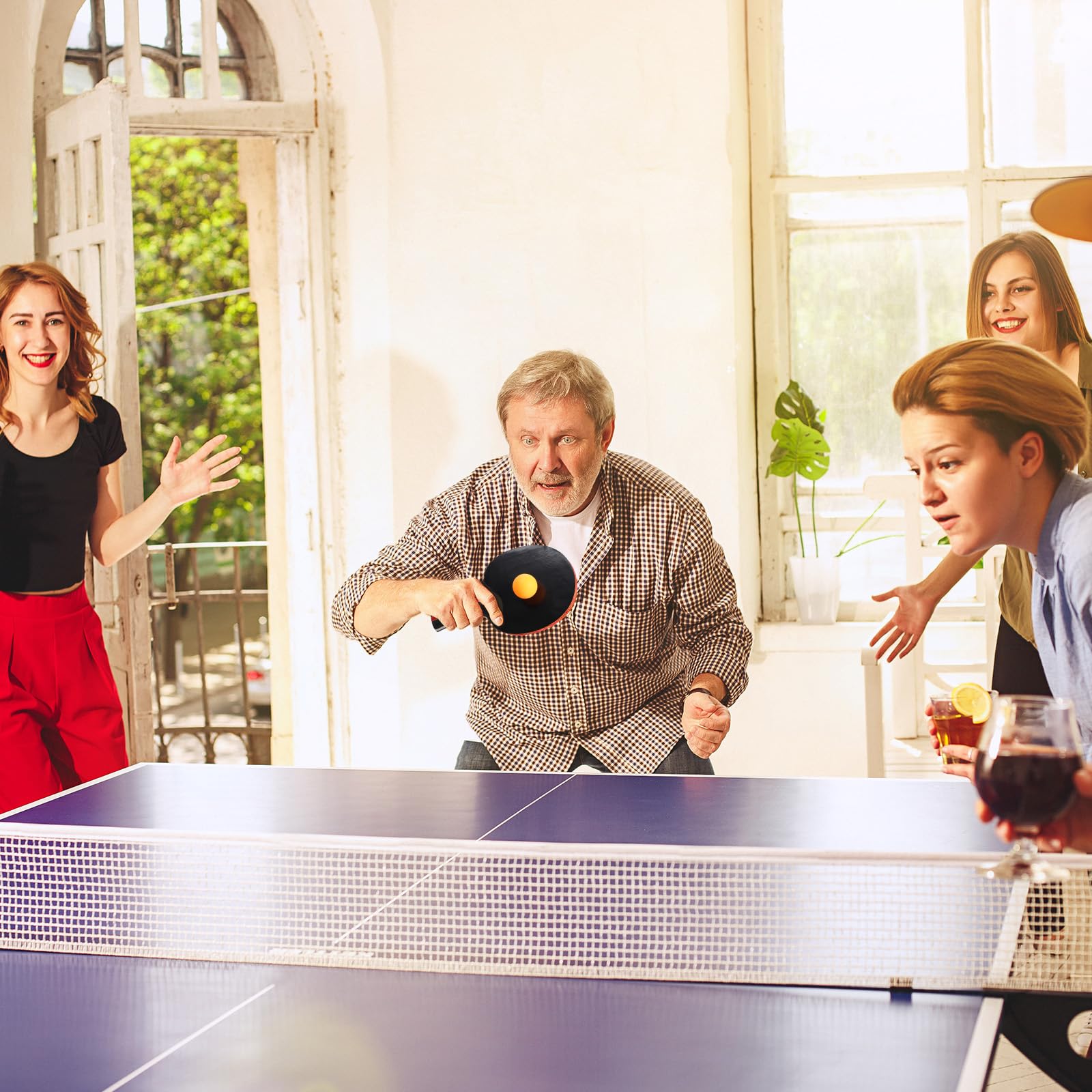 Liliful family playing table tennis outdoors, promoting healthy group activity