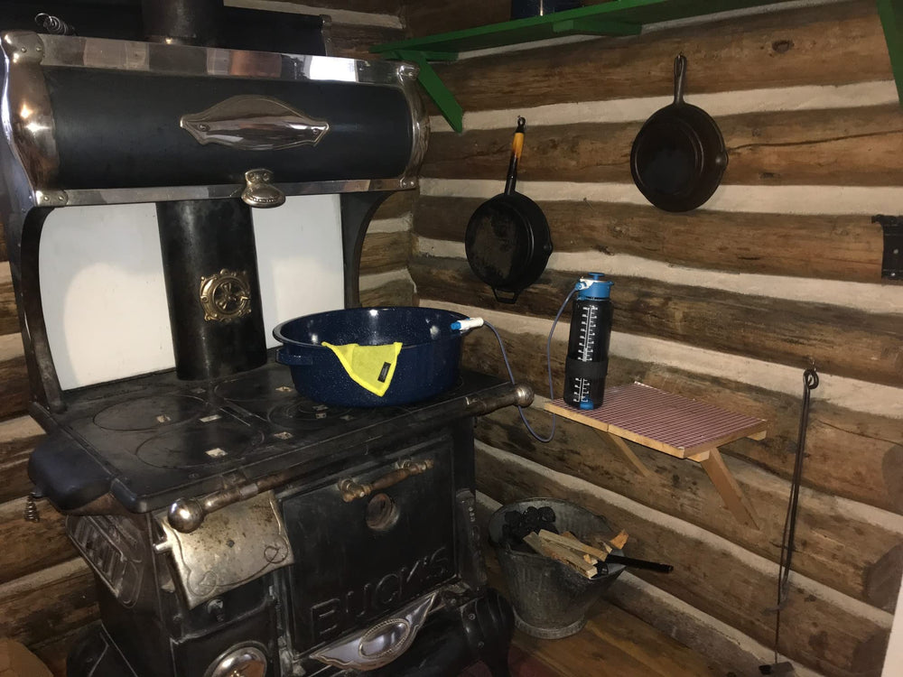 Lunatec on a campsite table showing portable hot and cold water benefits