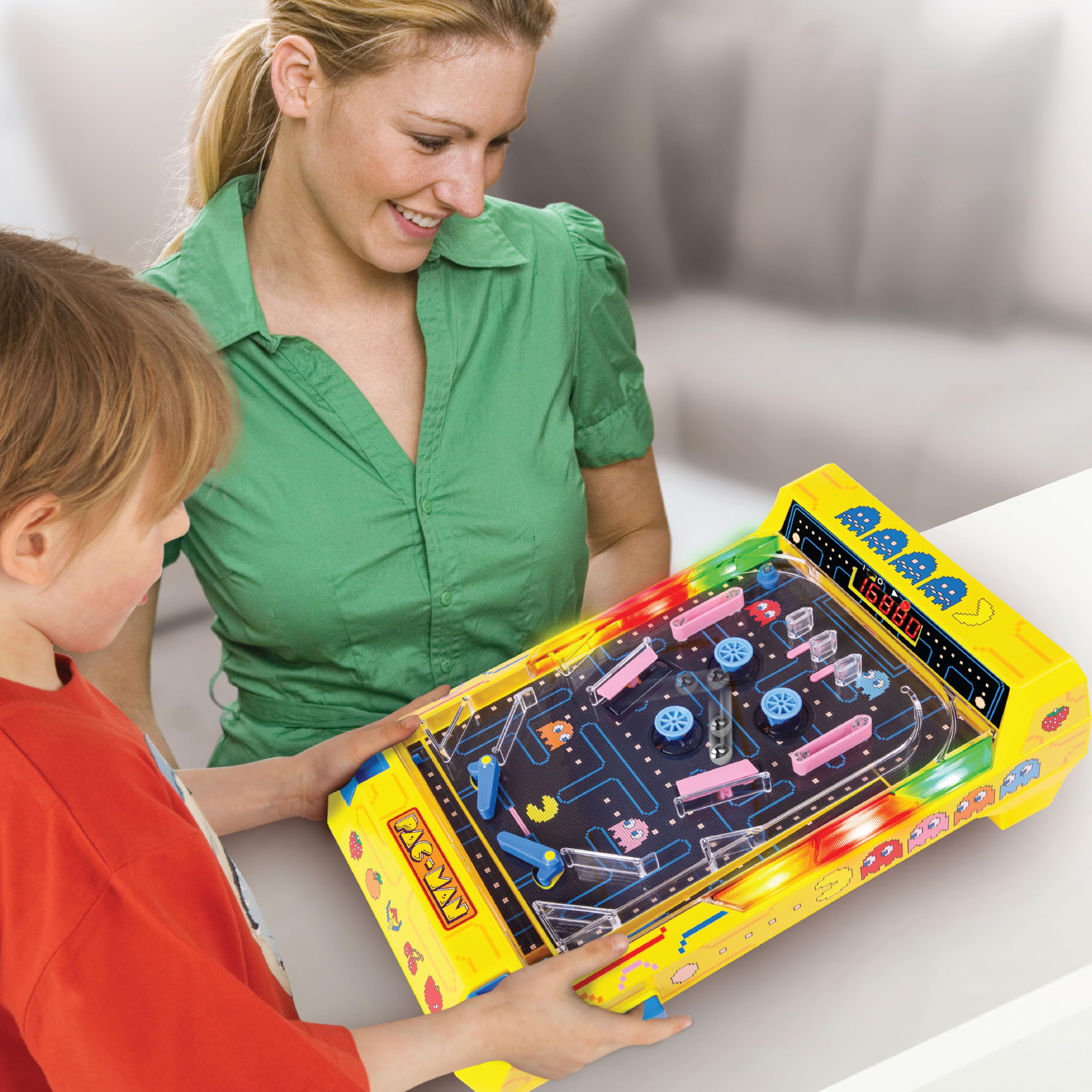 Merchant Ambassador PAC-MAN family around table enjoying competitive pinball rounds