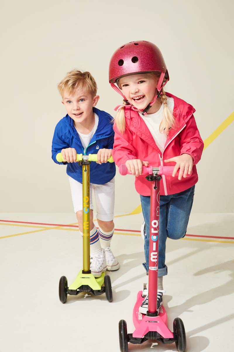 Micro Kickboard Maxi next to child for size comparison and fit guidance