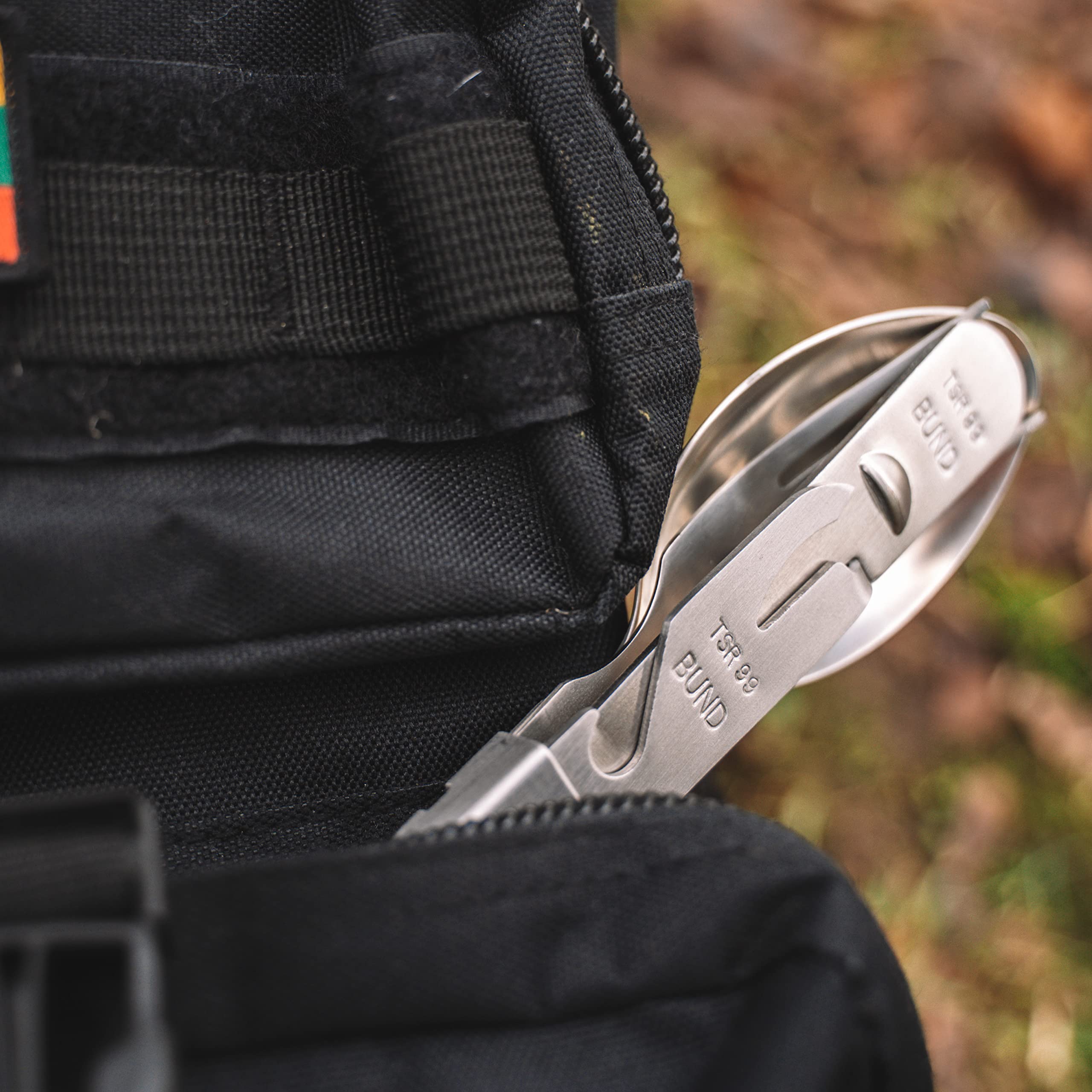 Militar cutlery components laid out displaying full-size fork spoon knife versatility