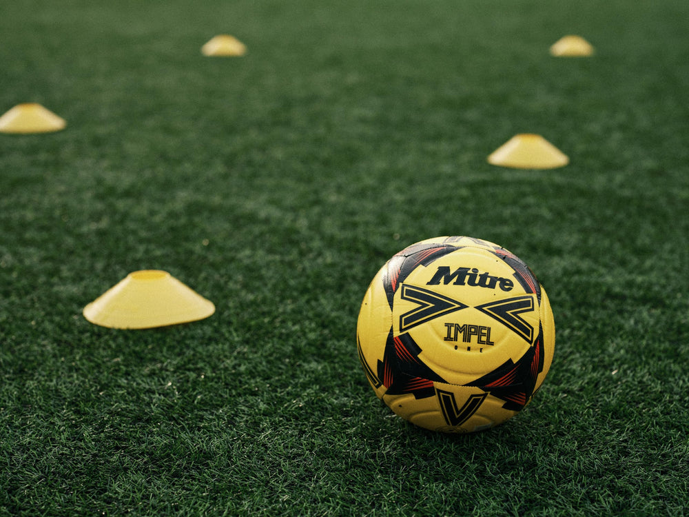 Mitre IMPEL ONE resting on AstroTurf ready for all-weather practice