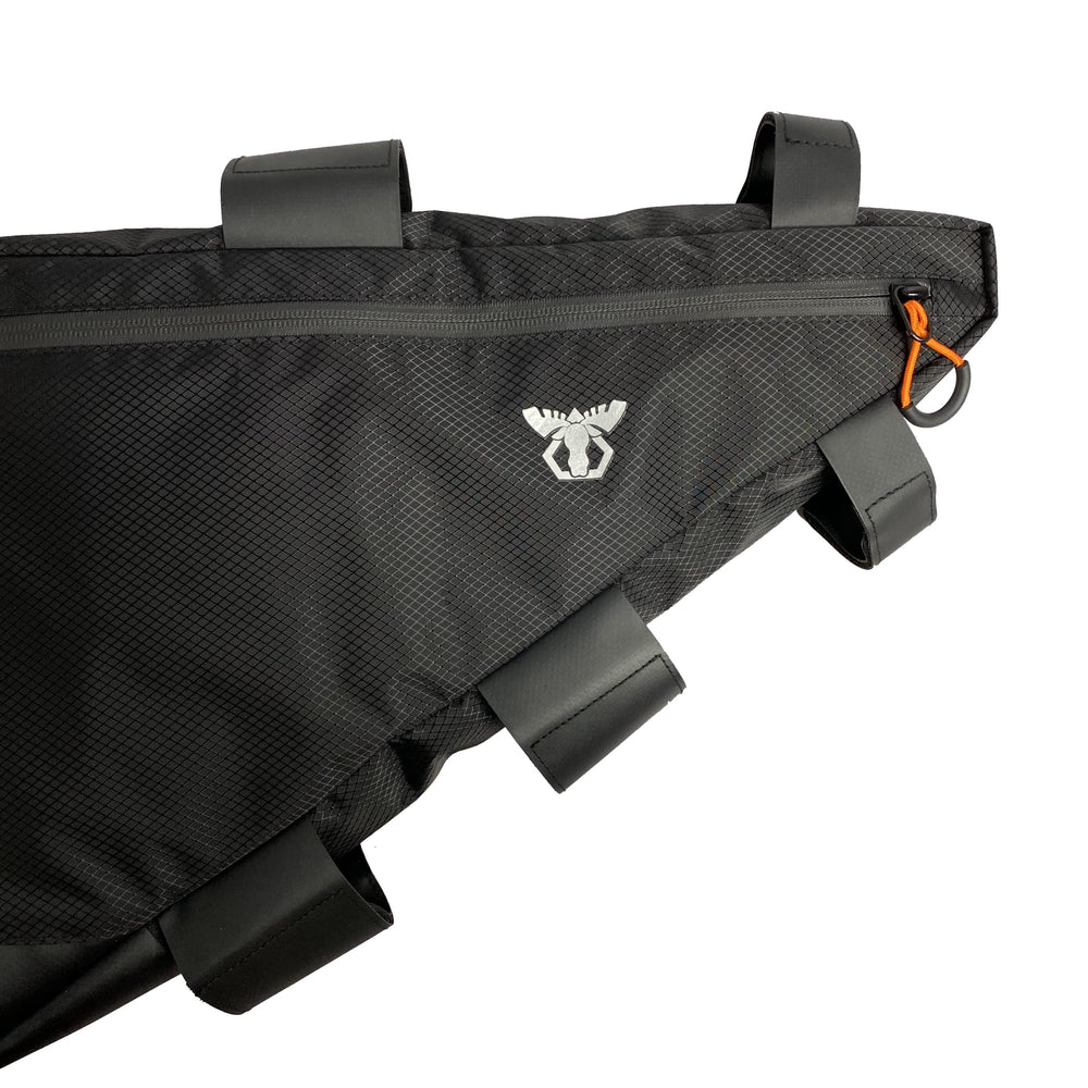 Moosetreks holding an e‑bike battery showing capacity and secure fit