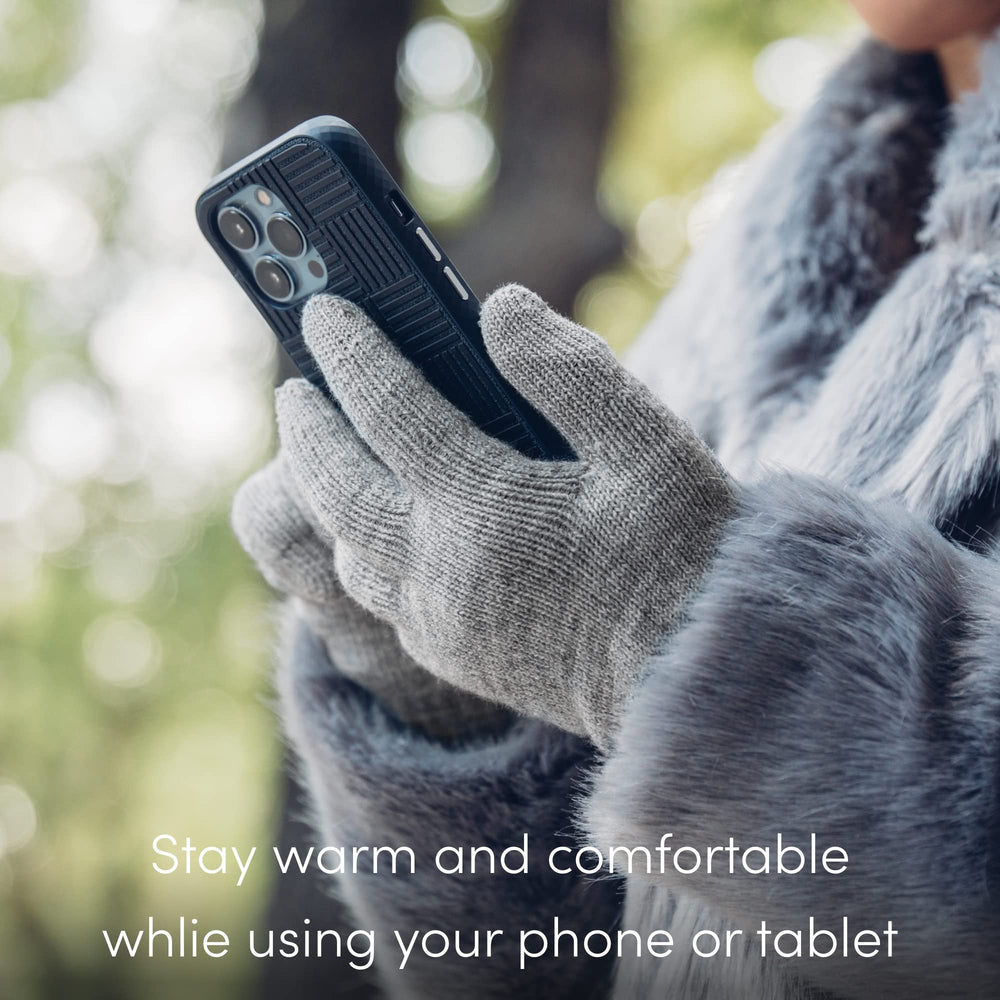 Person wearing Moshi Digits texting on smartphone outdoors, allowing use without removing gloves
