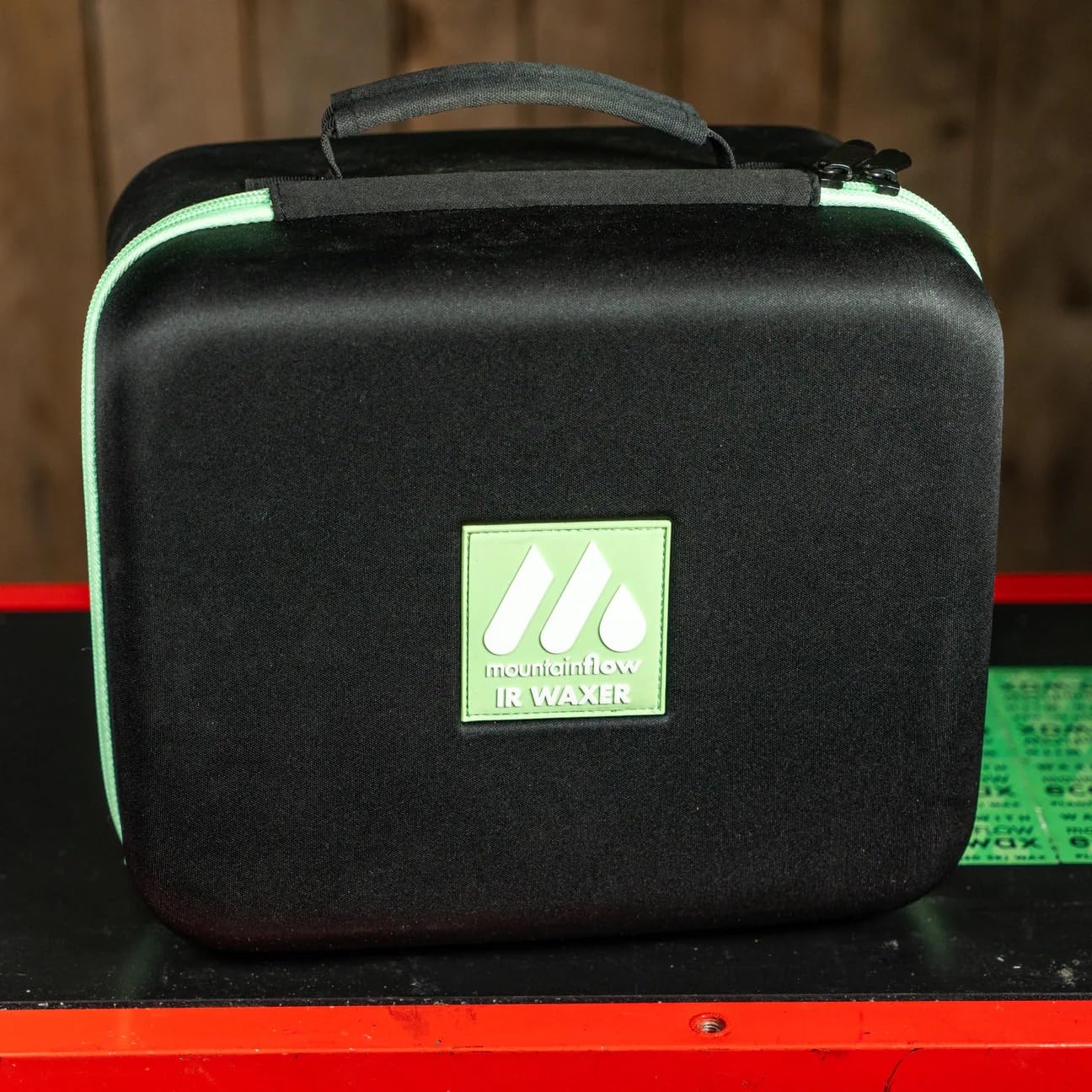 mountainFLOW waxer in use on ski base, demonstrating easy on-the-go waxing and less mess