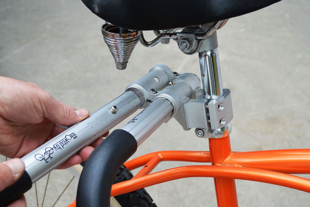 Moved By Bikes rack next to bicycle showing scale and compact storage advantage