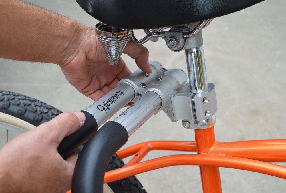 Moved By Bikes rack carrying boogie board on urban ride showing practical transport benefit