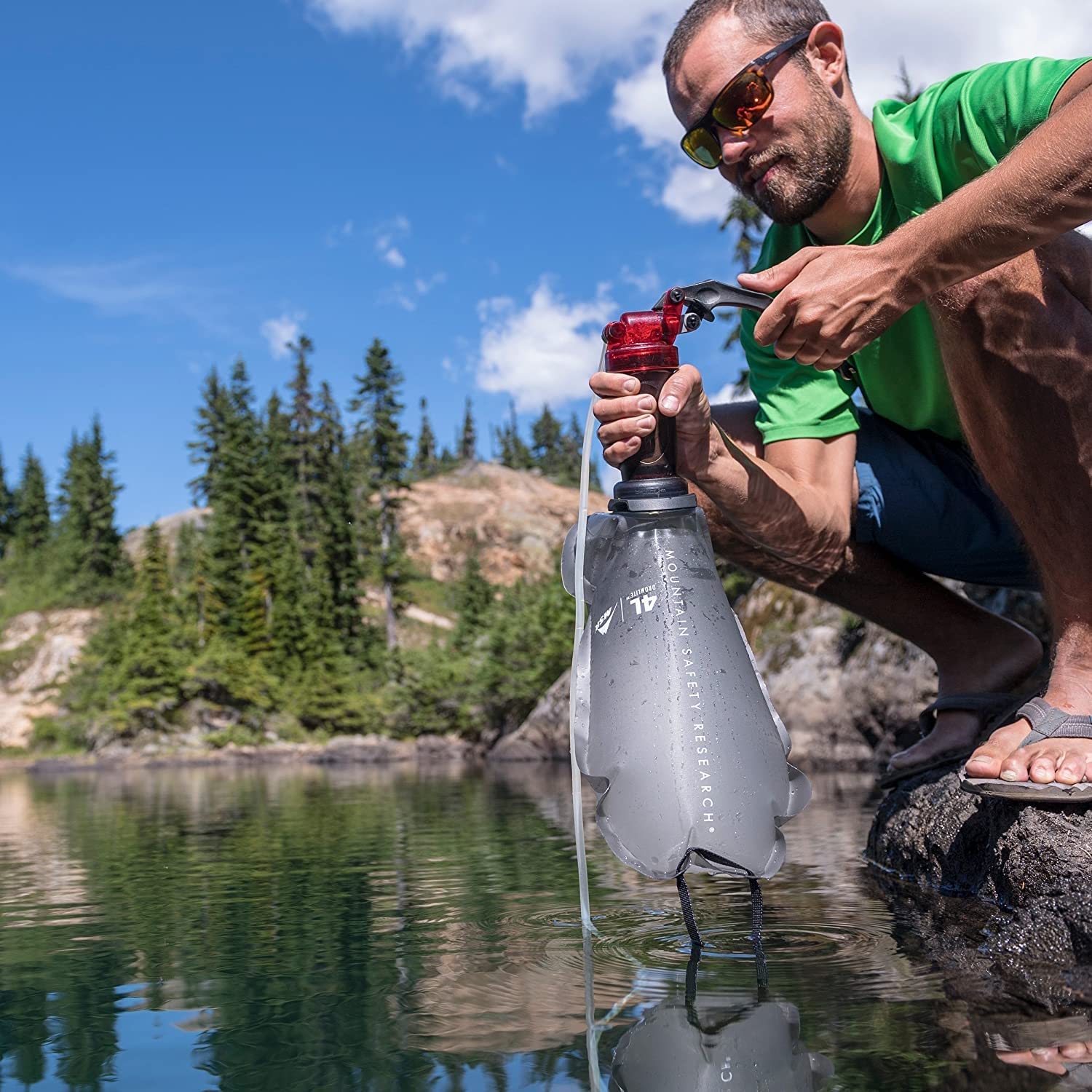 Hiker using MSR DromLite in field demonstrating quick access hydration